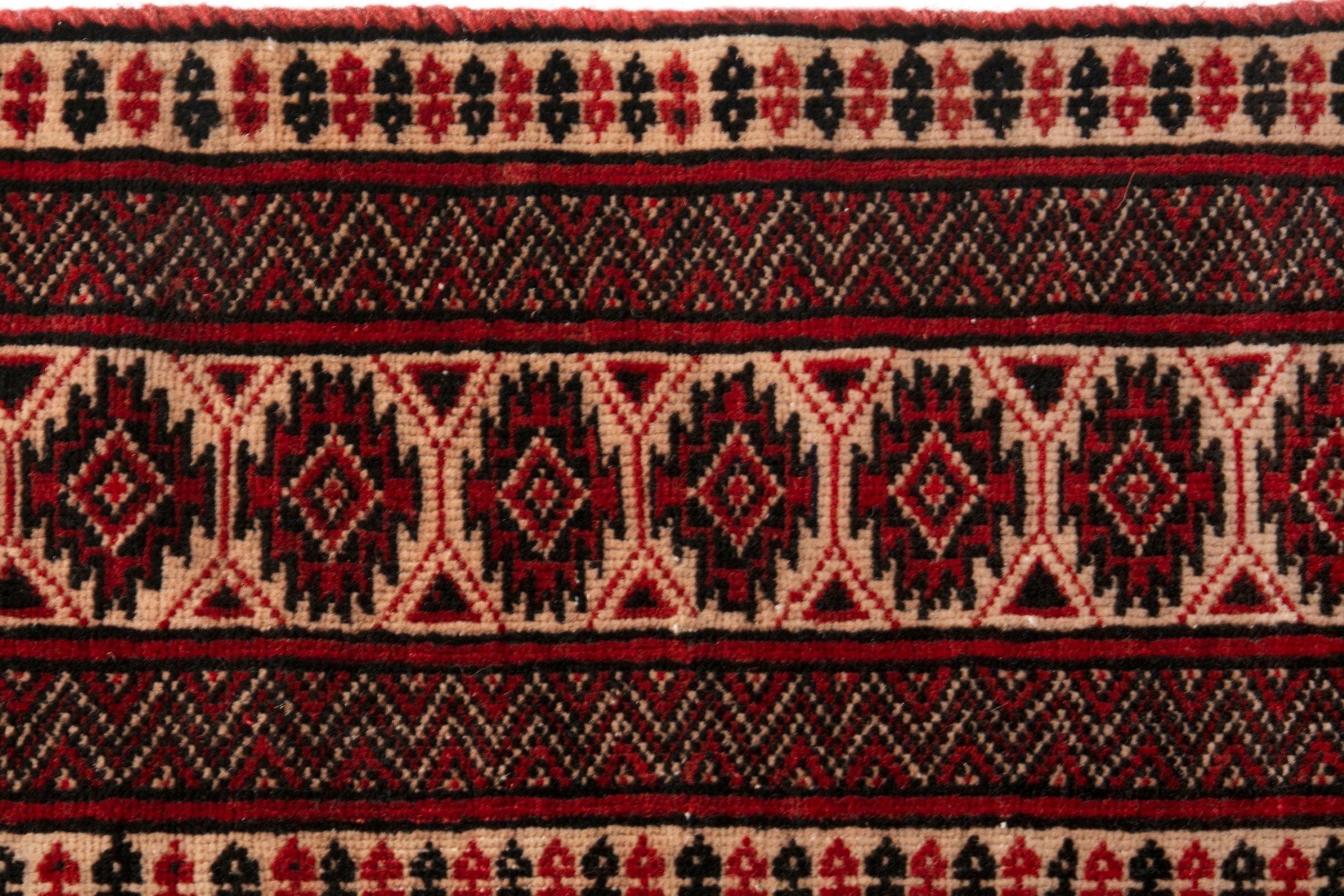 Persian Torkaman accent rug in navy and rust, view 13 of 19