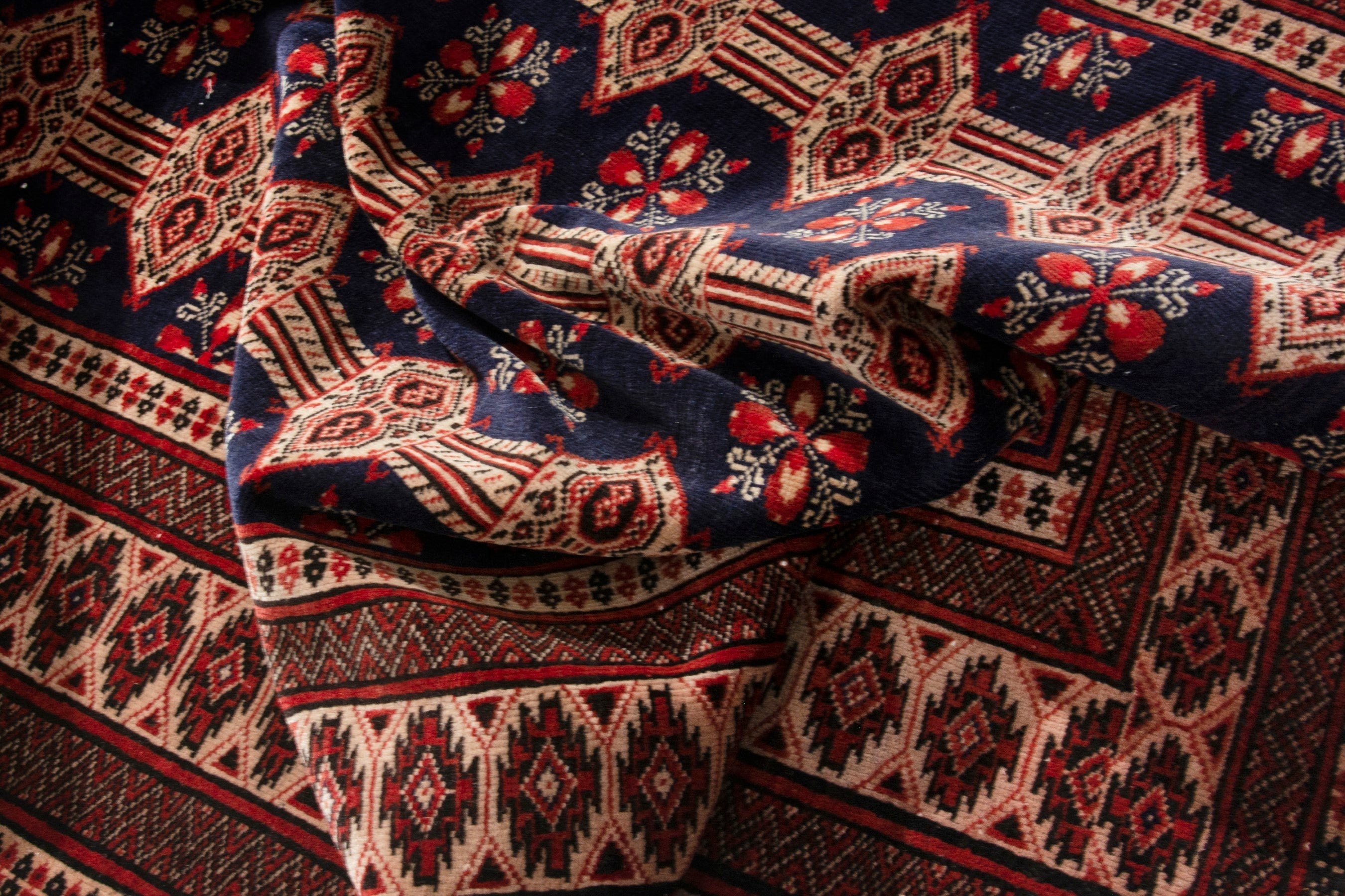 Persian Torkaman accent rug in navy and rust, view 16 of 19