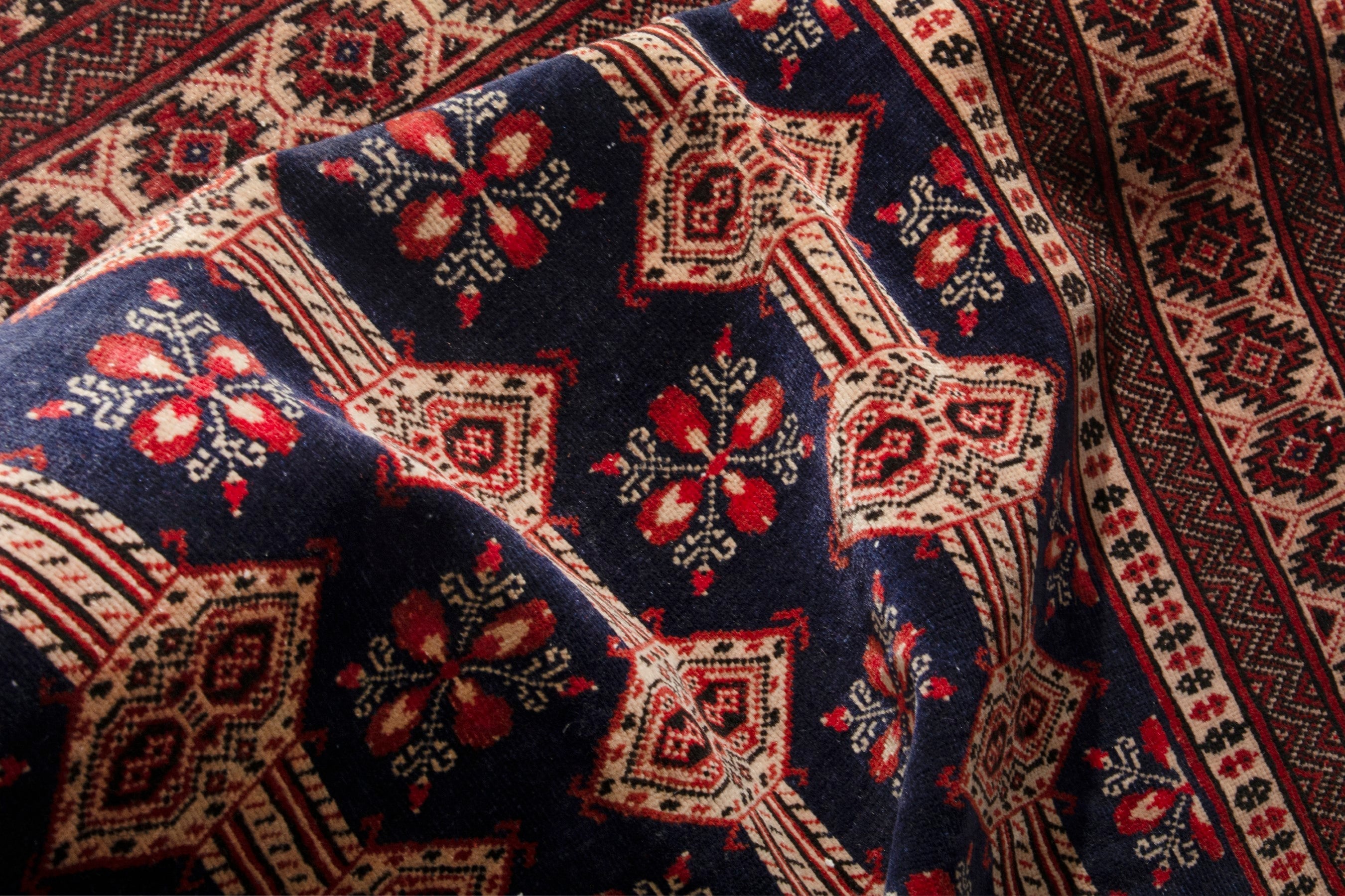 Persian Torkaman accent rug in navy and rust, view 17 of 19