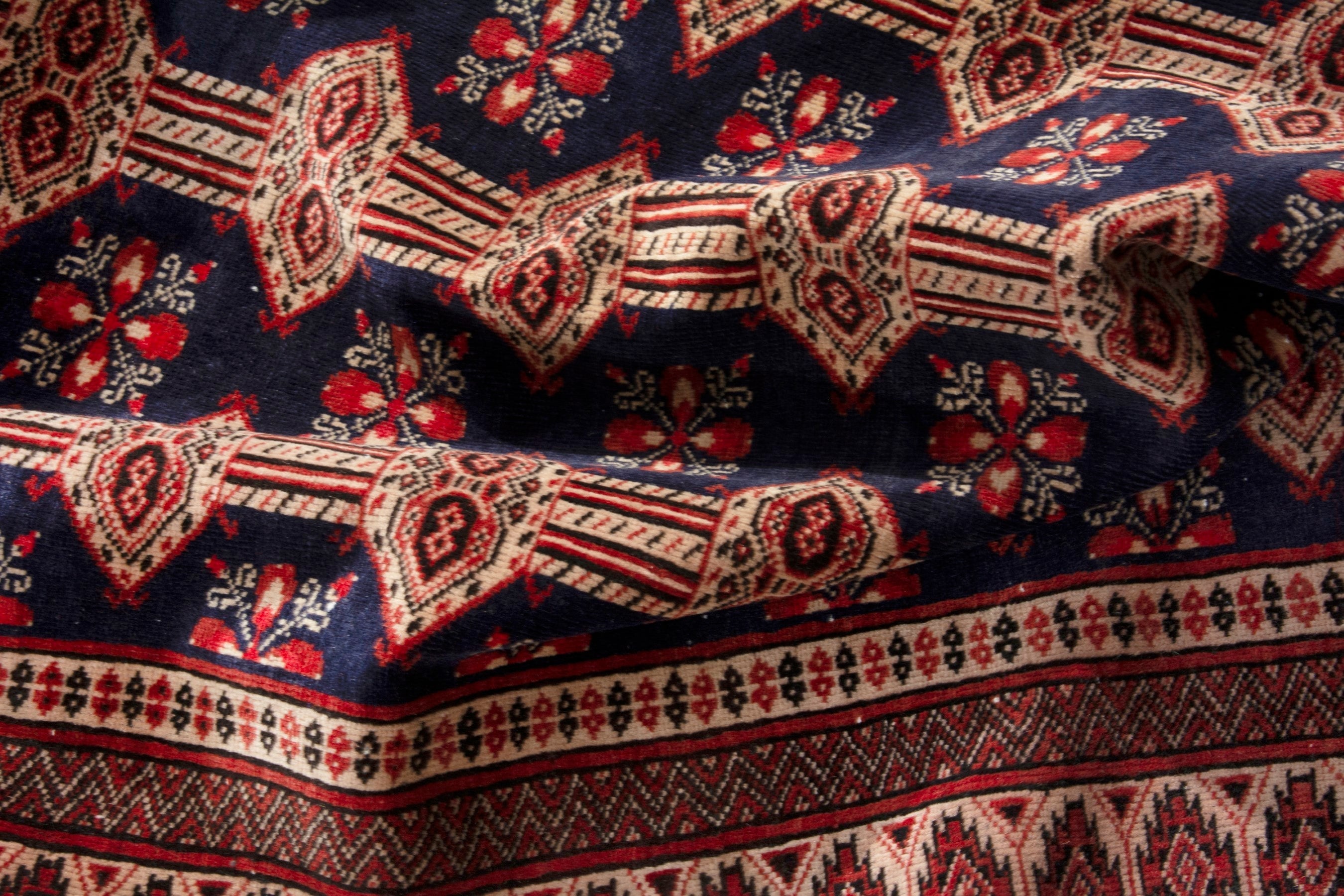 Persian Torkaman accent rug in navy and rust, view 18 of 19