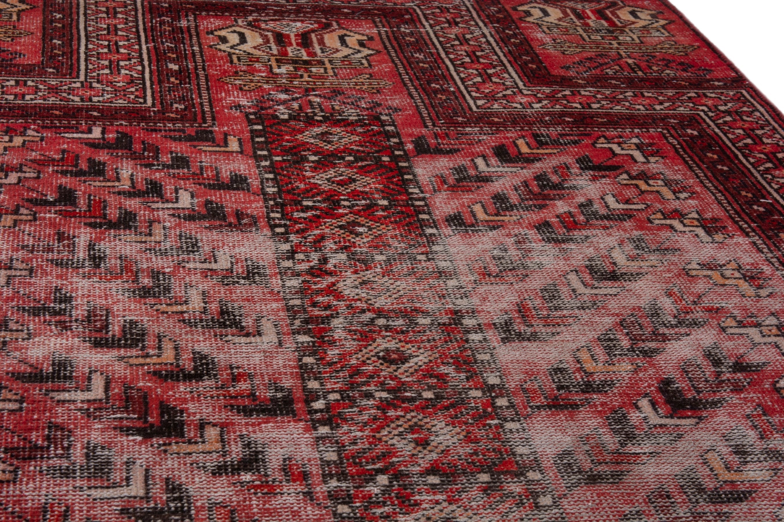Persian Baluch area rug in faded red and deep red, view 7 of 19
