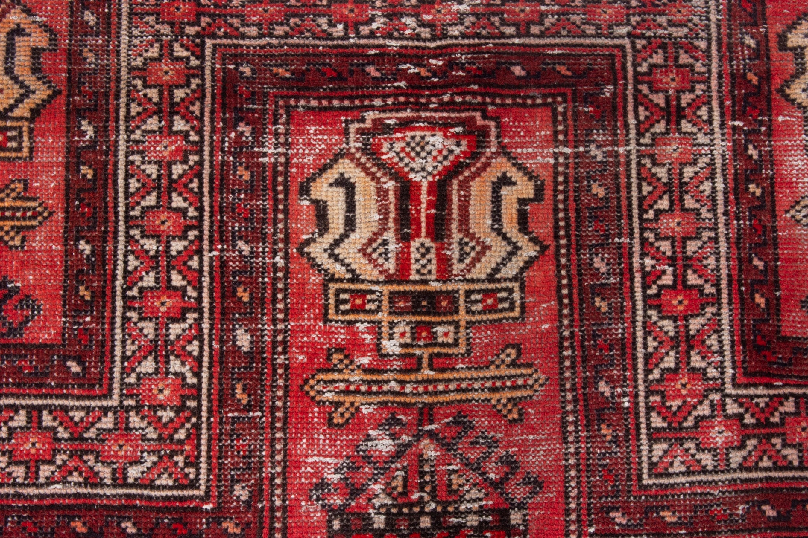 Persian Baluch area rug in faded red and deep red, view 14 of 19