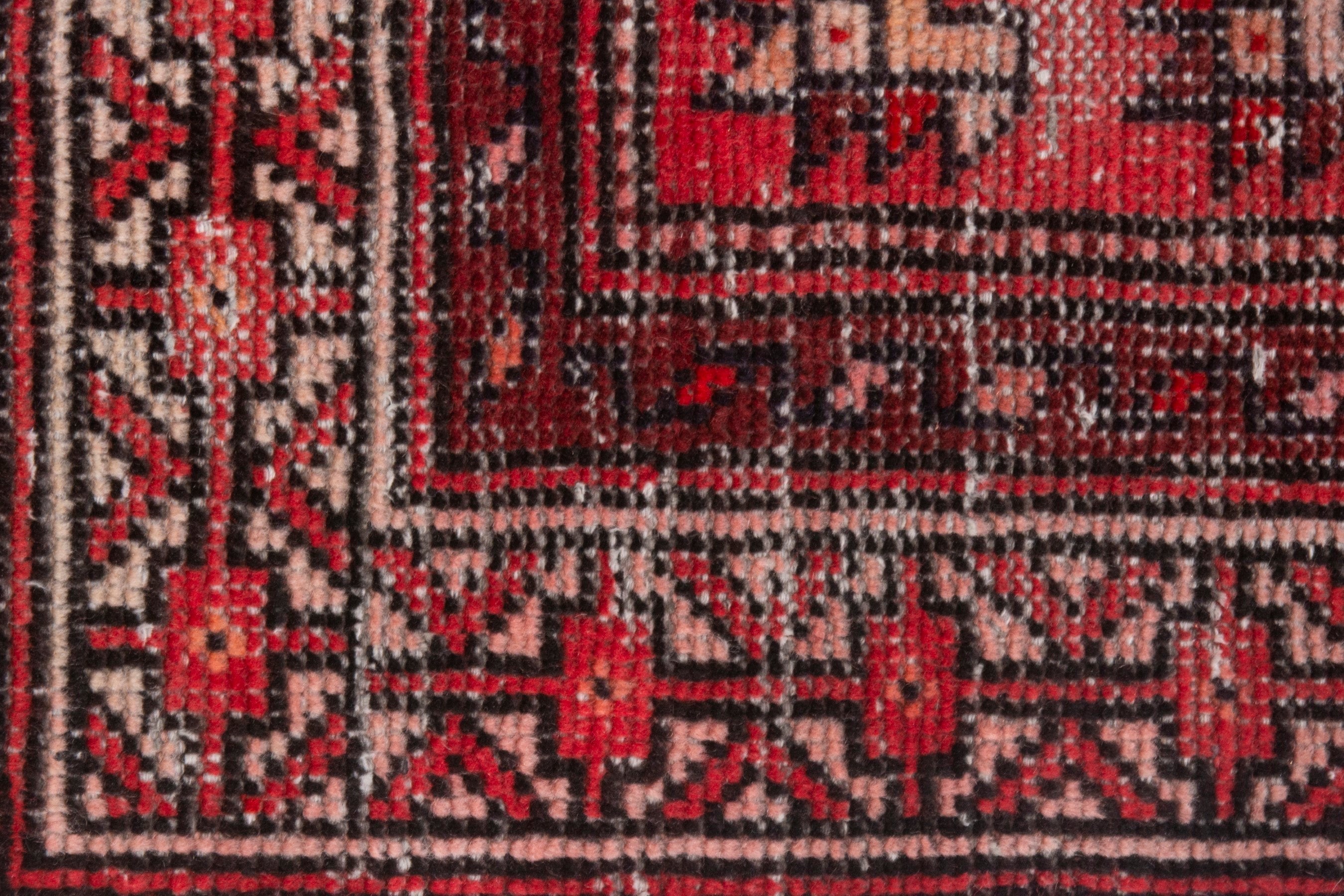 Persian Baluch area rug in faded red and deep red, view 13 of 19