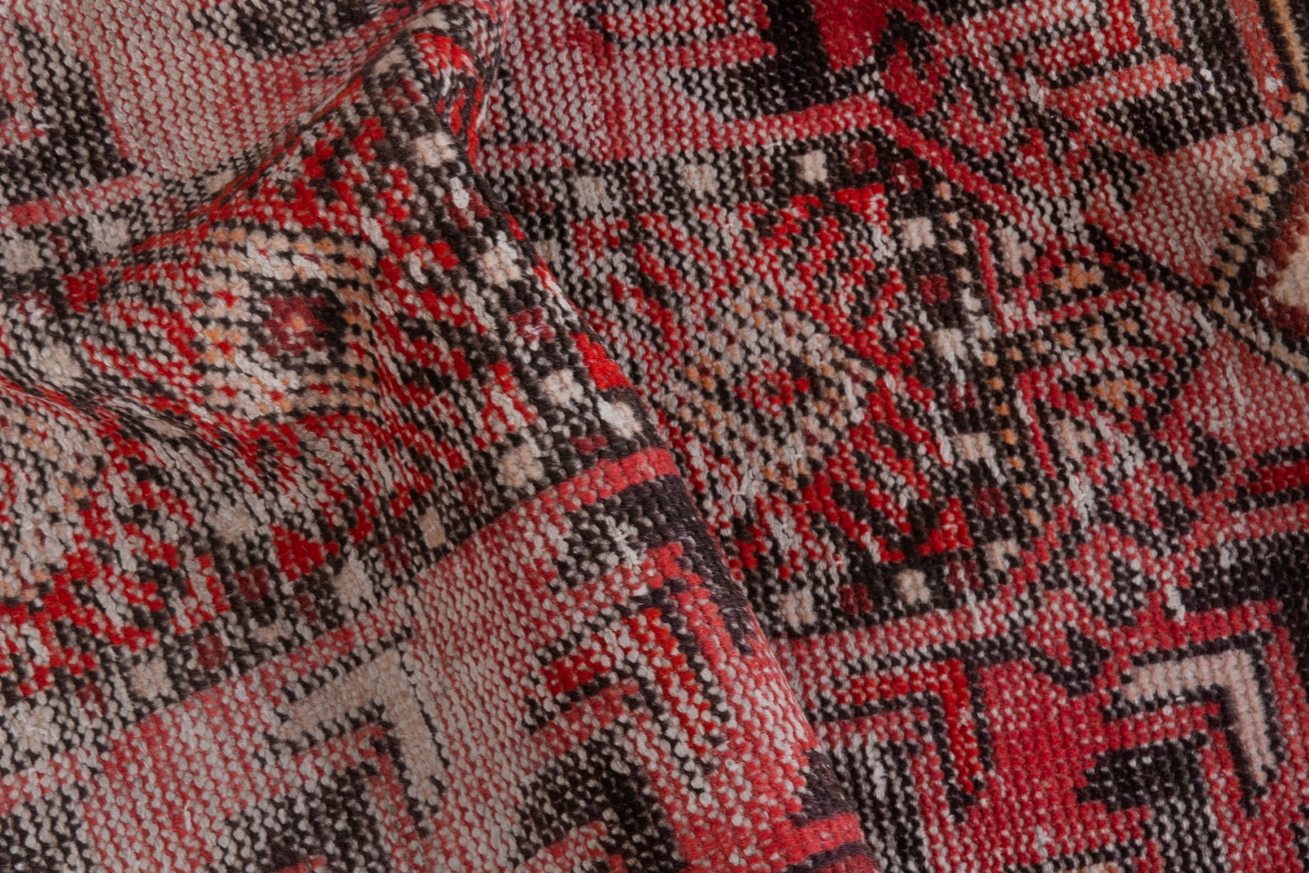 Persian Baluch area rug in faded red and deep red, view 18 of 19
