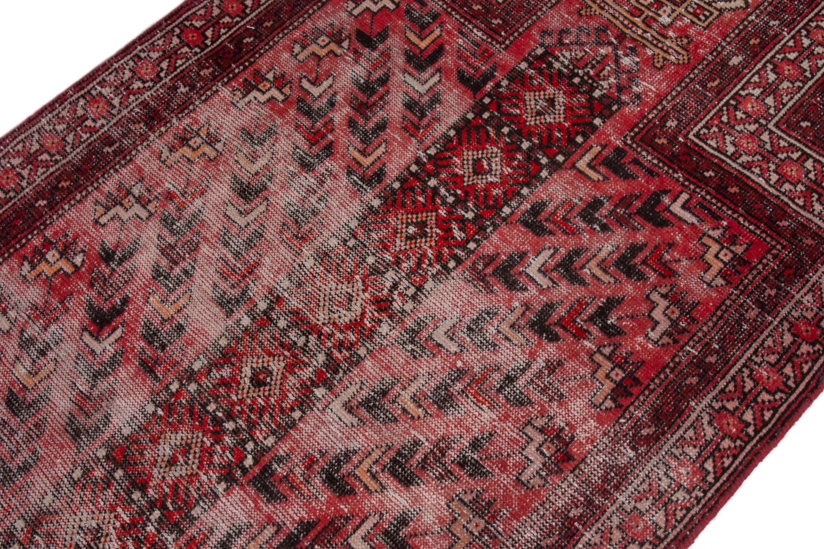 Persian Baluch area rug in faded red and deep red, view 8 of 19