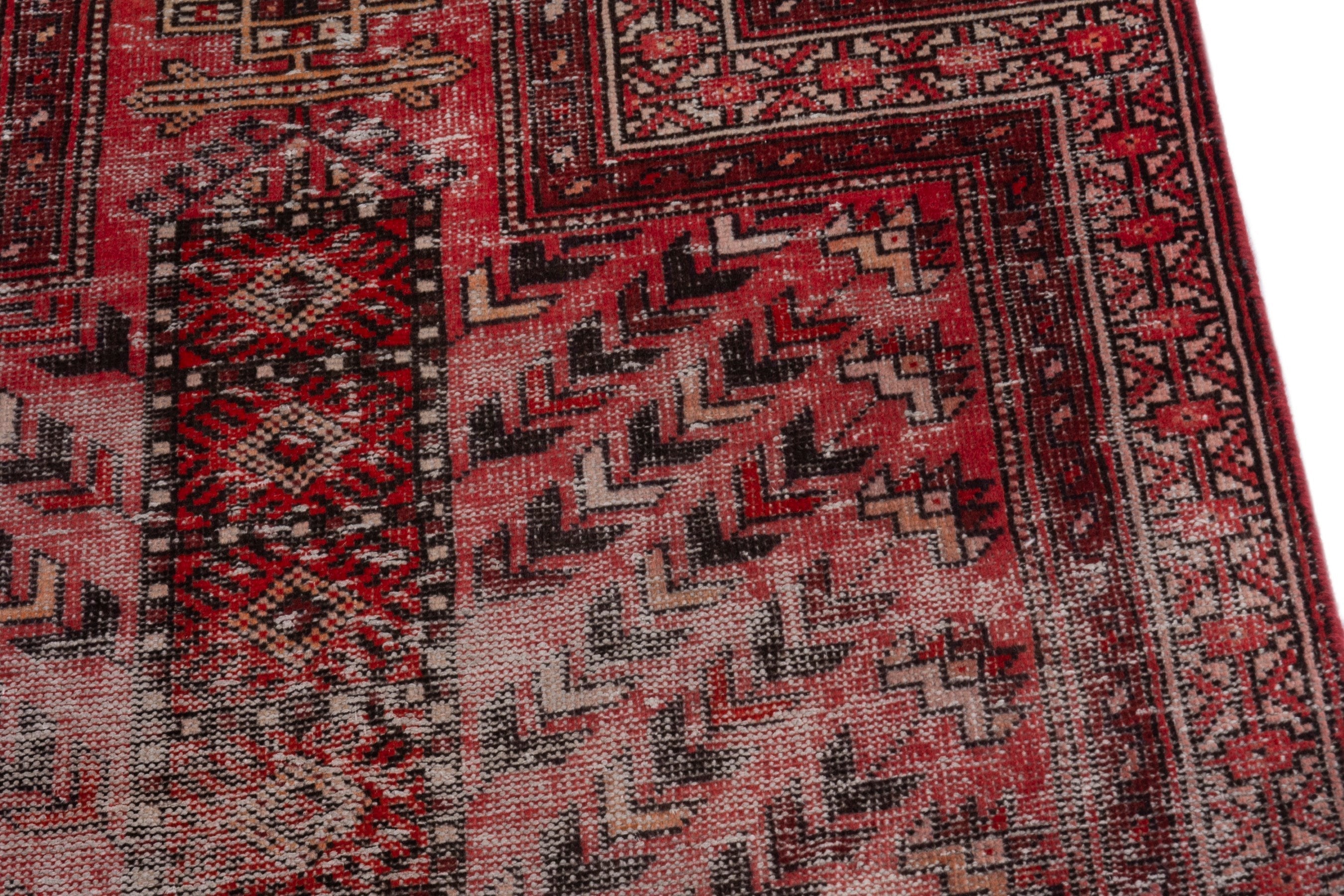Persian Baluch area rug in faded red and deep red, view 9 of 19