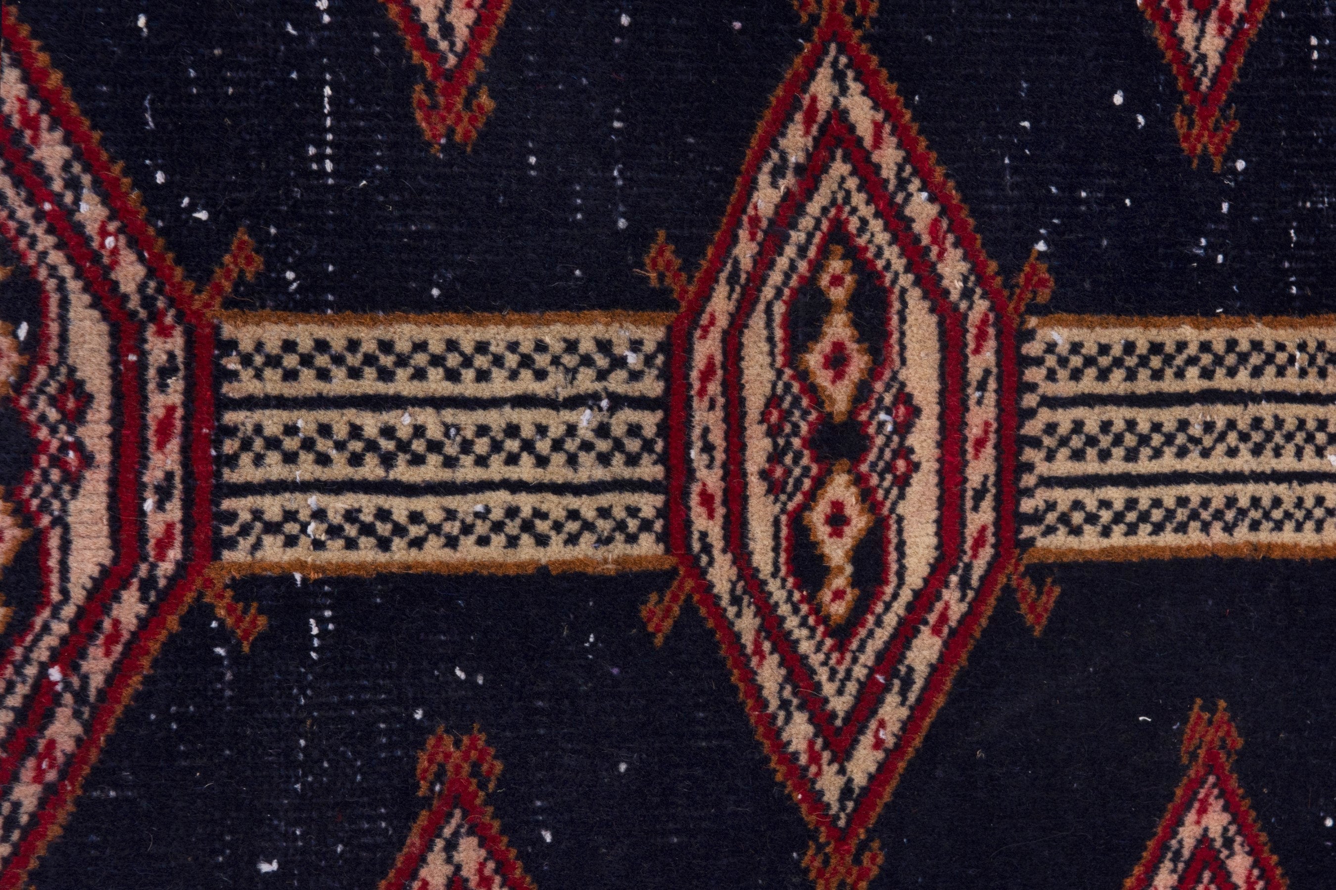 Persian Torkaman accent rug in navy and deep red, view 6 of 7