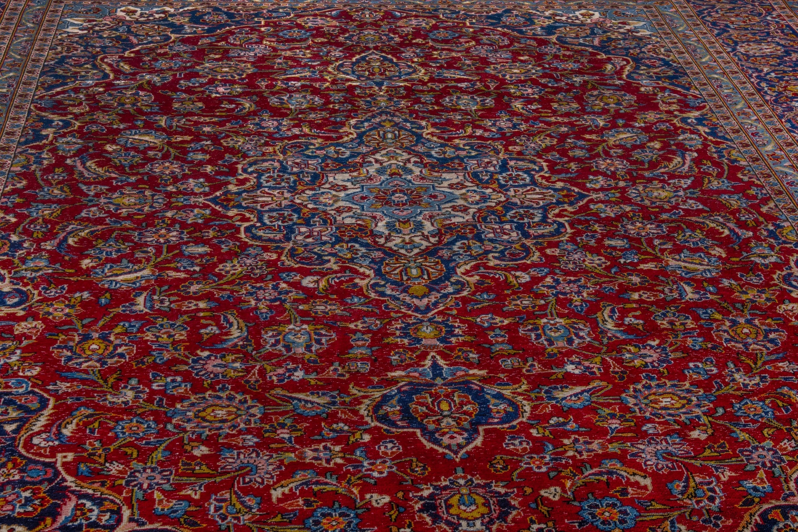 Persian Kashan oversized rug in deep red and dark blue, view 9 of 21