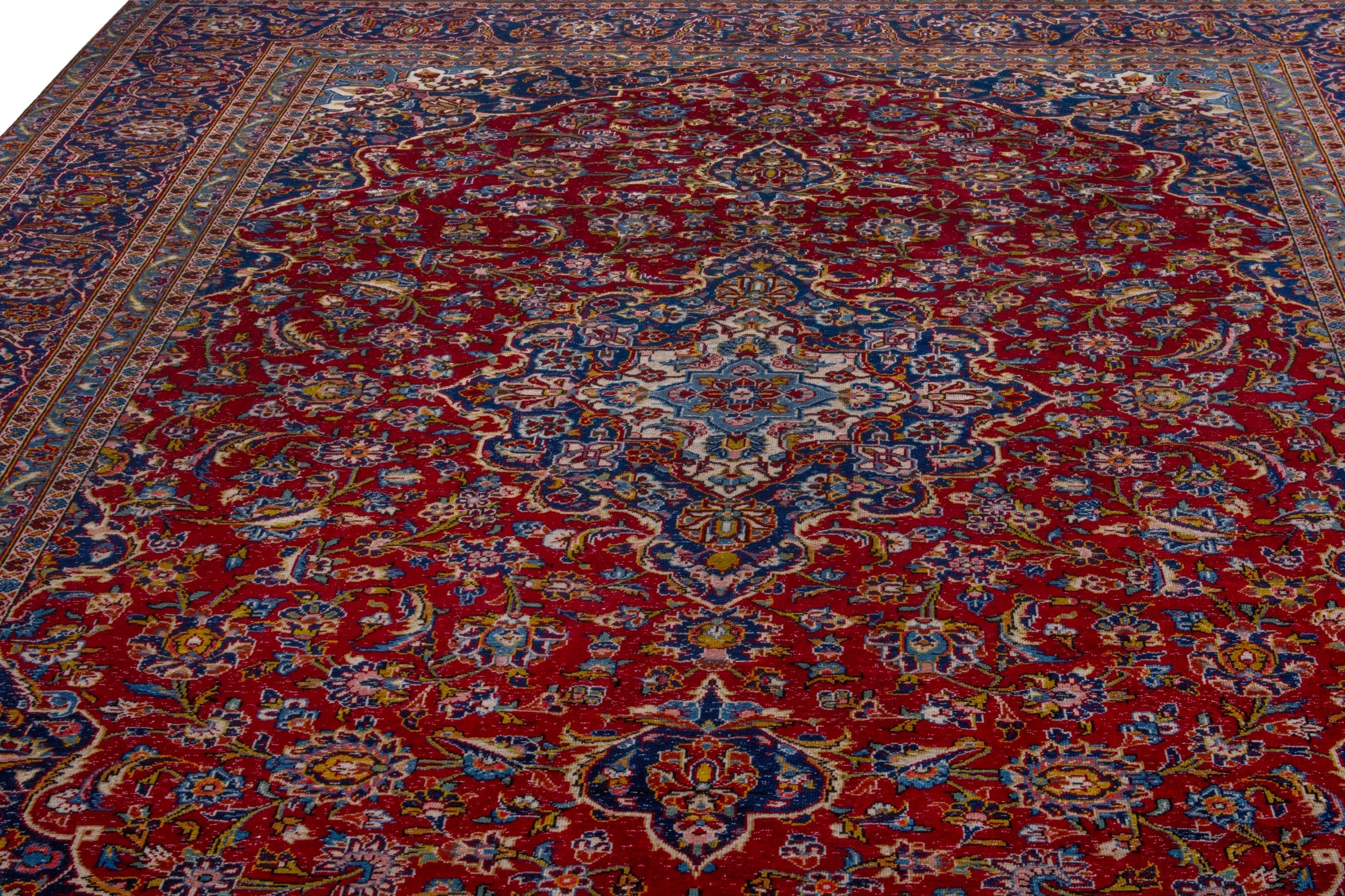 Persian Kashan oversized rug in deep red and dark blue, view 8 of 21