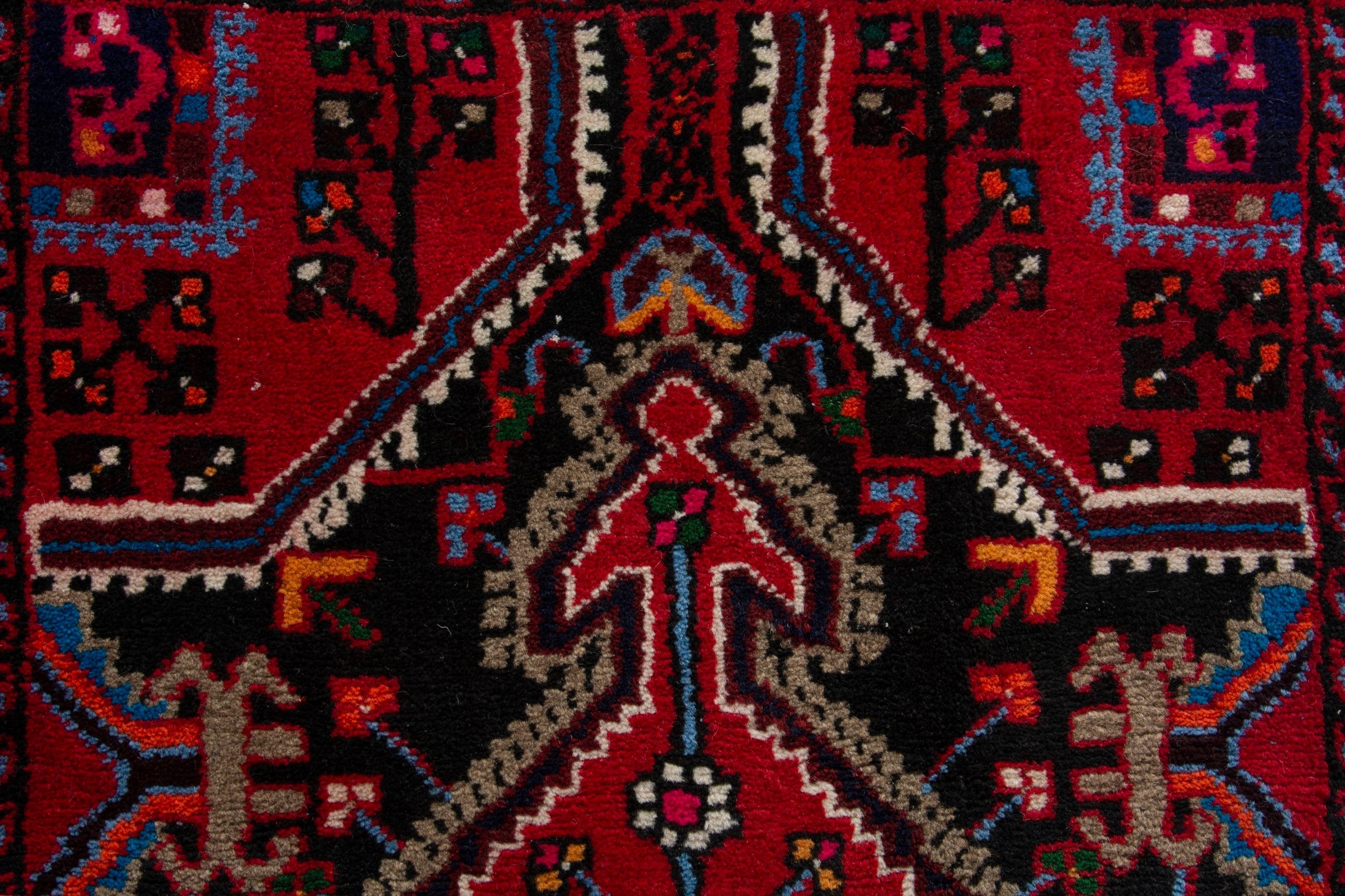 Persian Toyserkan accent rug in deep red and burgundy, view 8 of 9