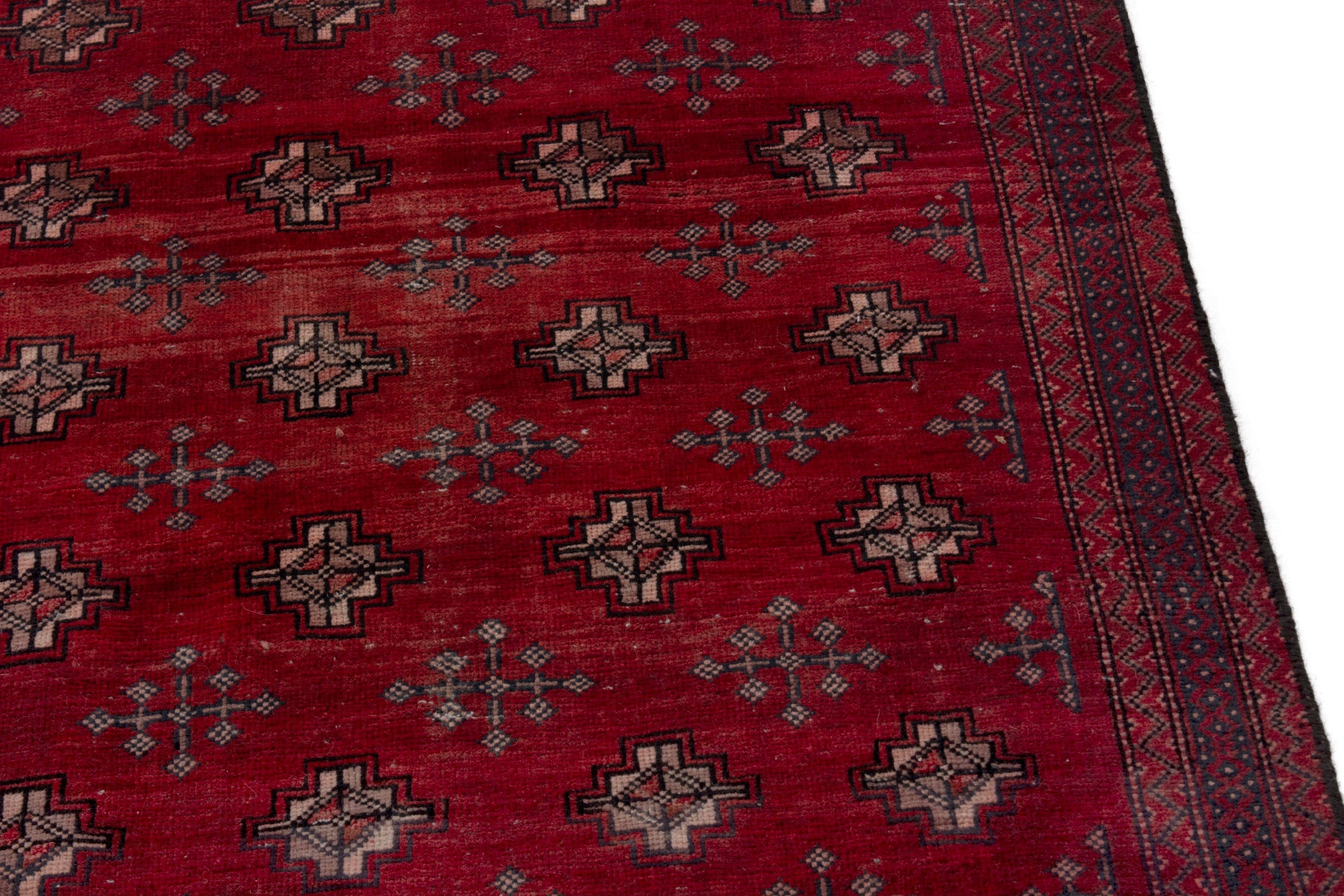 Persian Torkaman area rug in deep red and cream, view 8 of 17