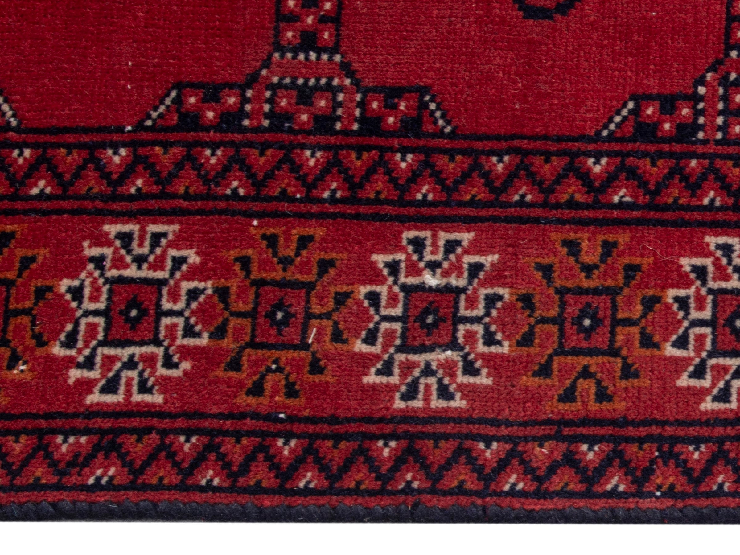 Persian Torkaman runner rug in deep red and cream, view 10 of 17