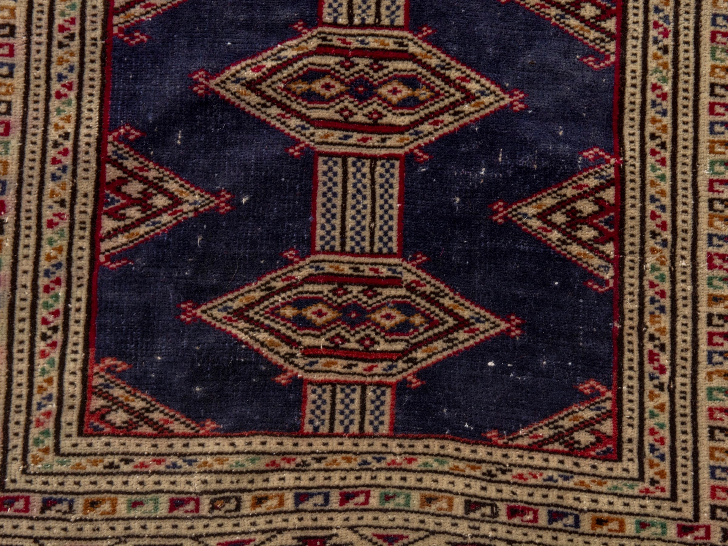 Persian Torkaman accent rug in navy and burgundy, view 11 of 17