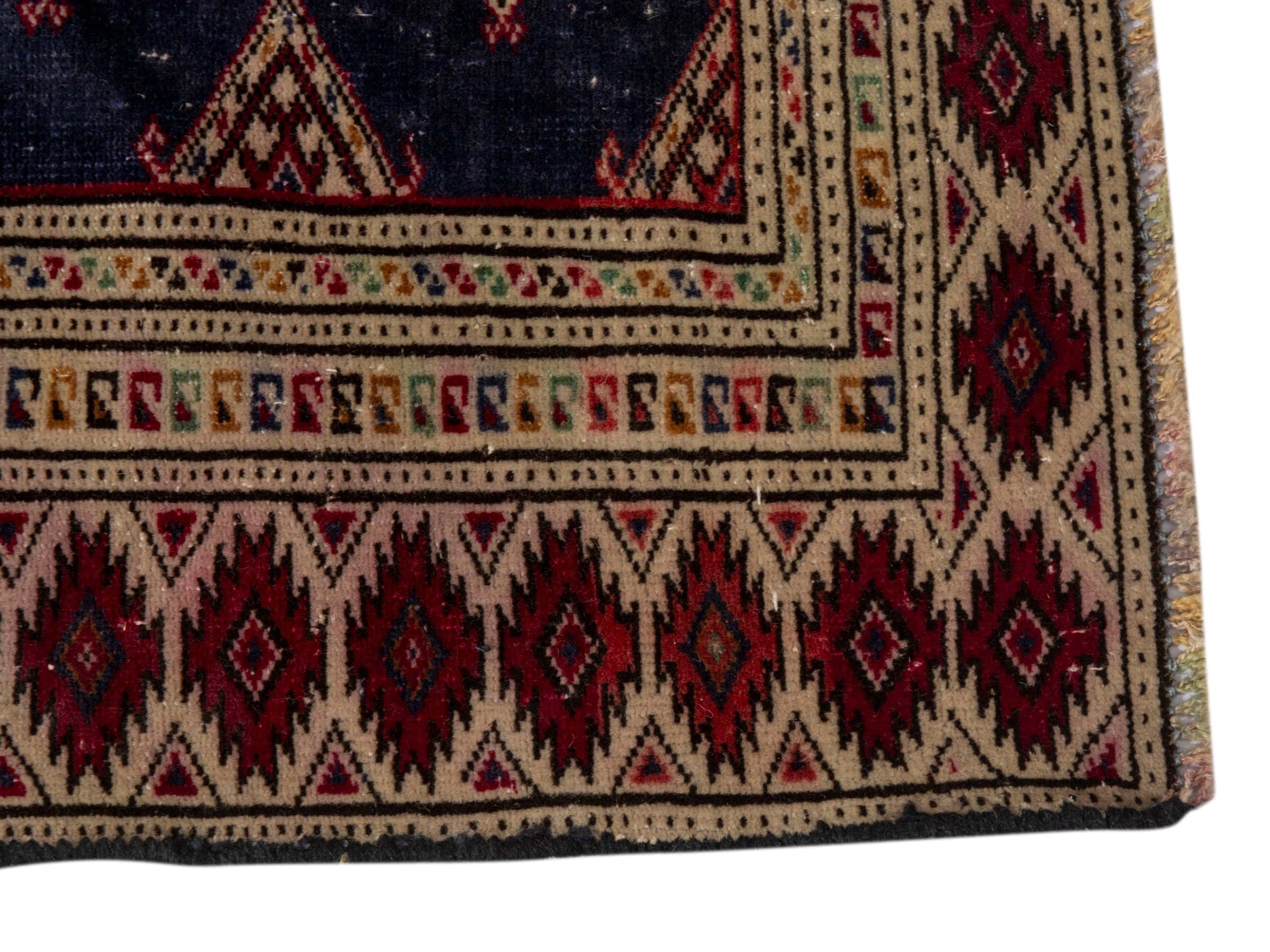 Persian Torkaman accent rug in navy and burgundy, view 10 of 17