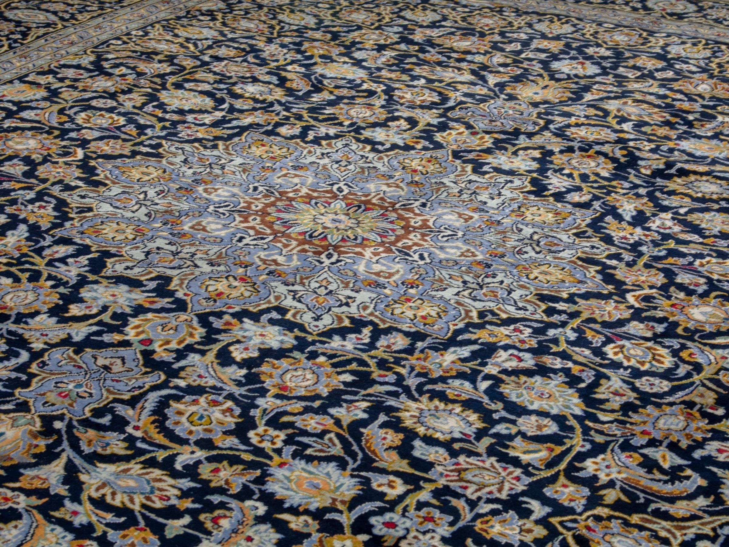 Persian Kashan oversized rug in navy and tan, view 7 of 20