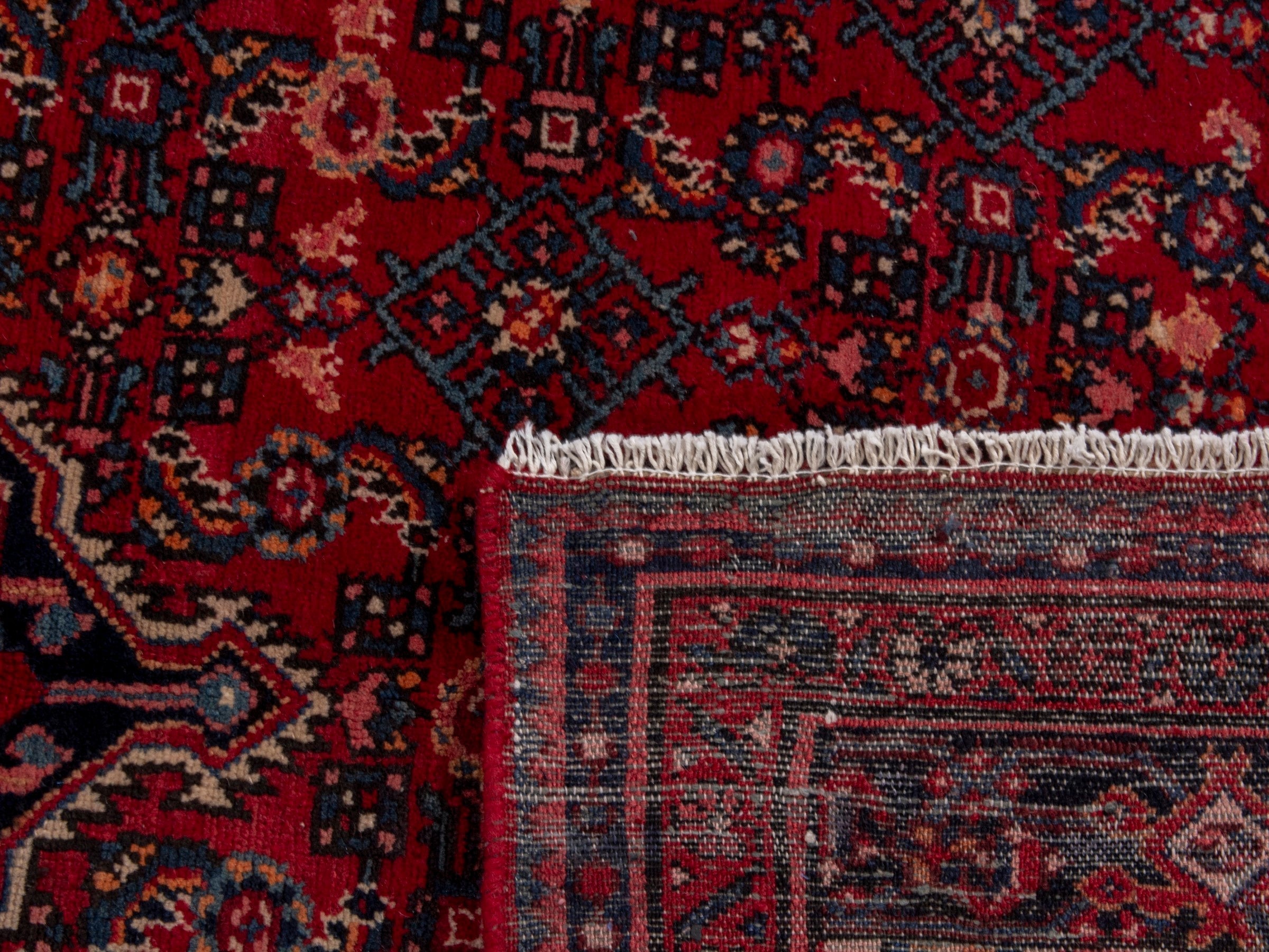 Persian Hosseinabad oversized rug in burgundy and navy, view 19 of 19
