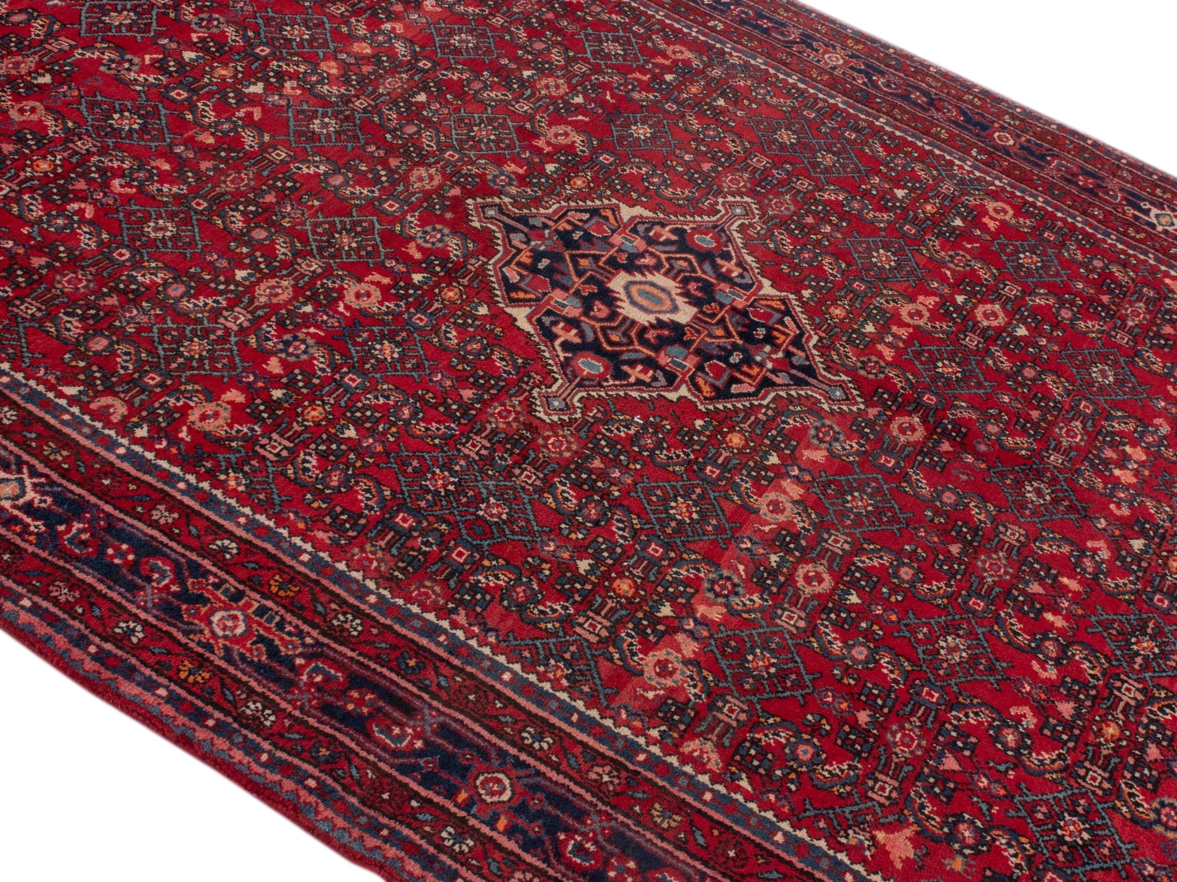 Persian Hosseinabad oversized rug in burgundy and navy, view 4 of 19
