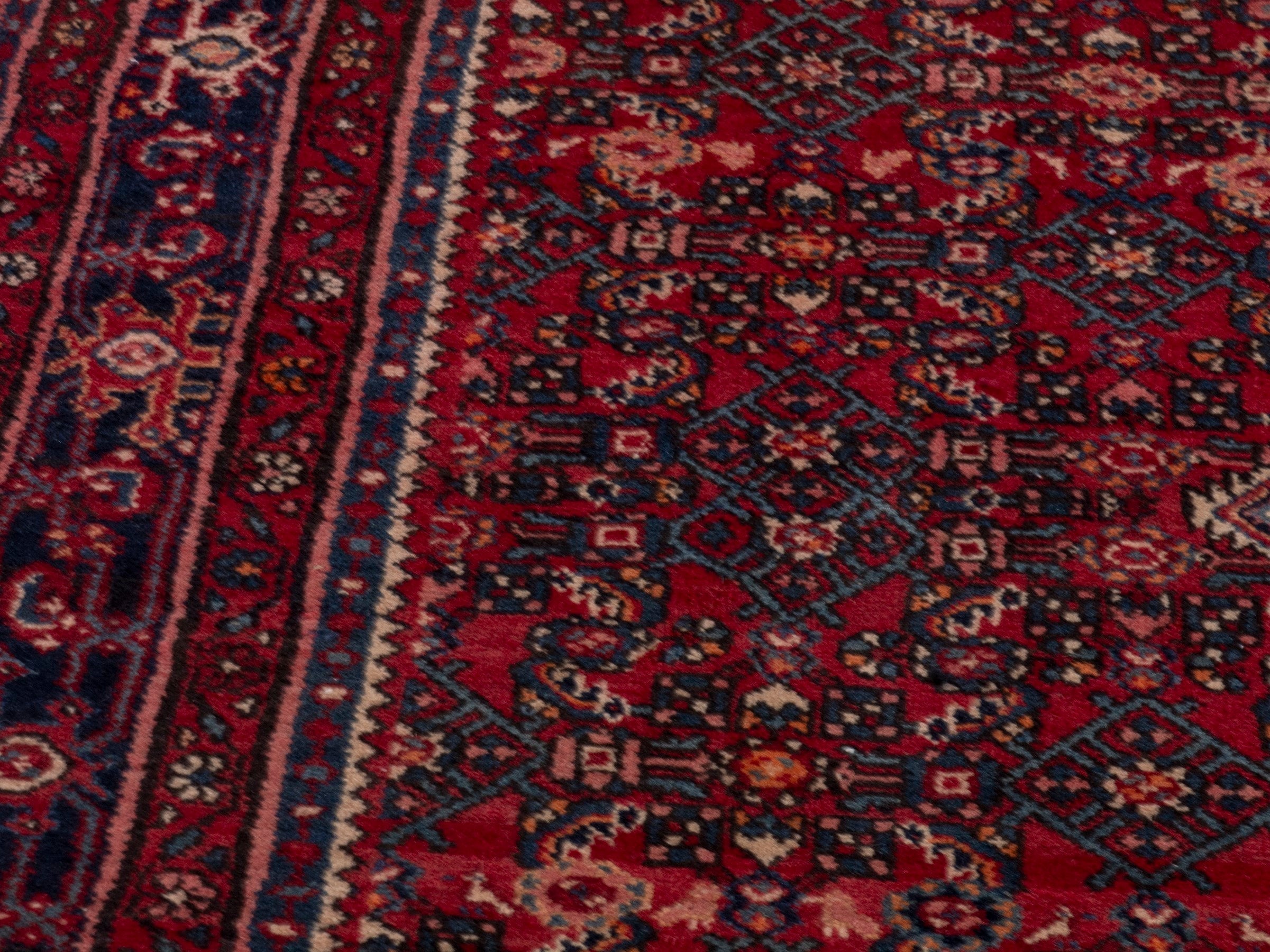 Persian Hosseinabad oversized rug in burgundy and navy, view 9 of 19