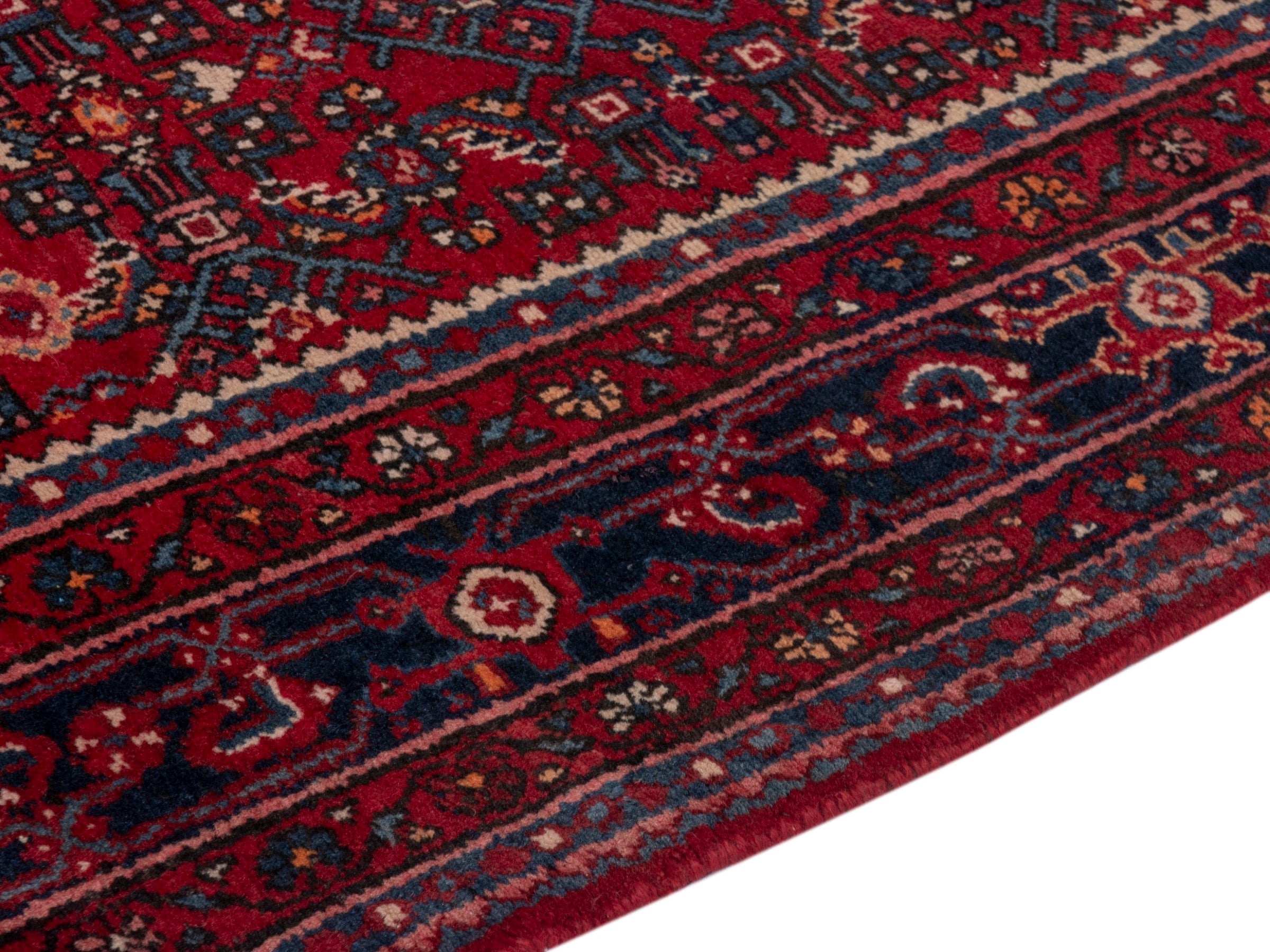 Persian Hosseinabad oversized rug in burgundy and navy, view 6 of 19