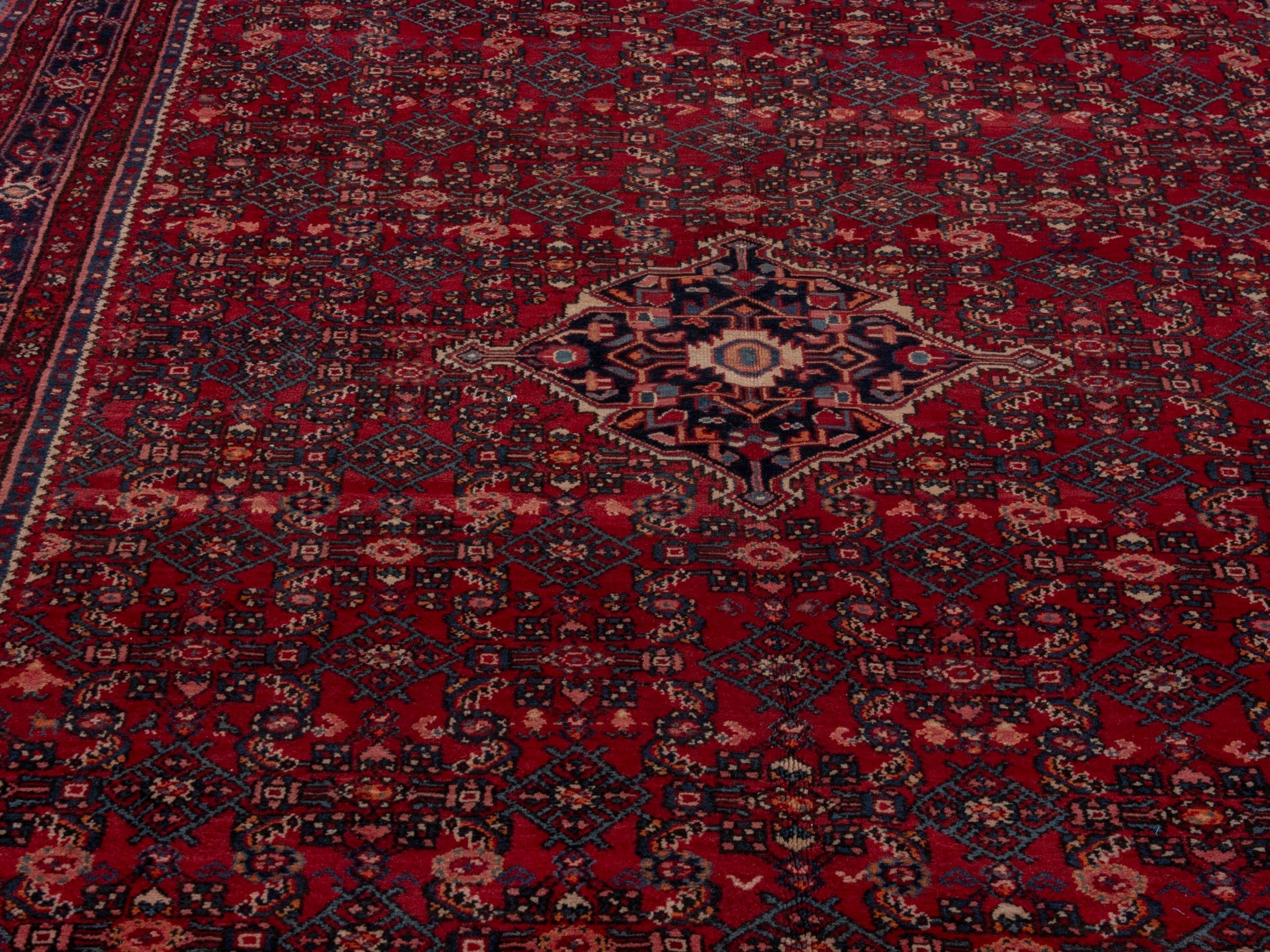 Persian Hosseinabad oversized rug in burgundy and navy, view 7 of 19