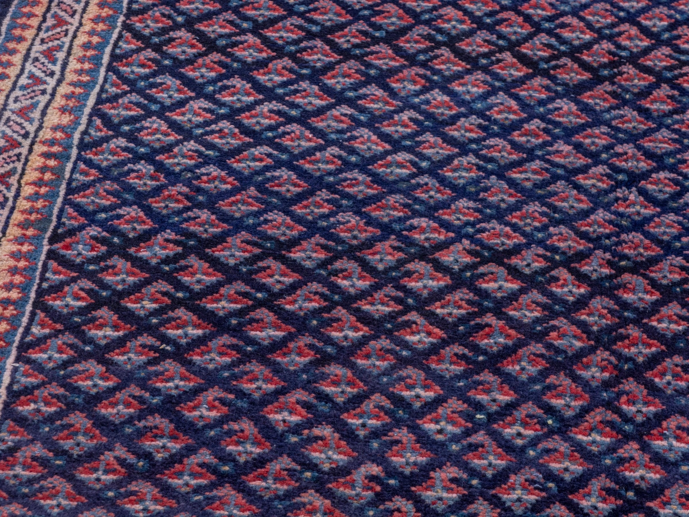 Persian Arak area rug in navy and dusty rose, view 9 of 19