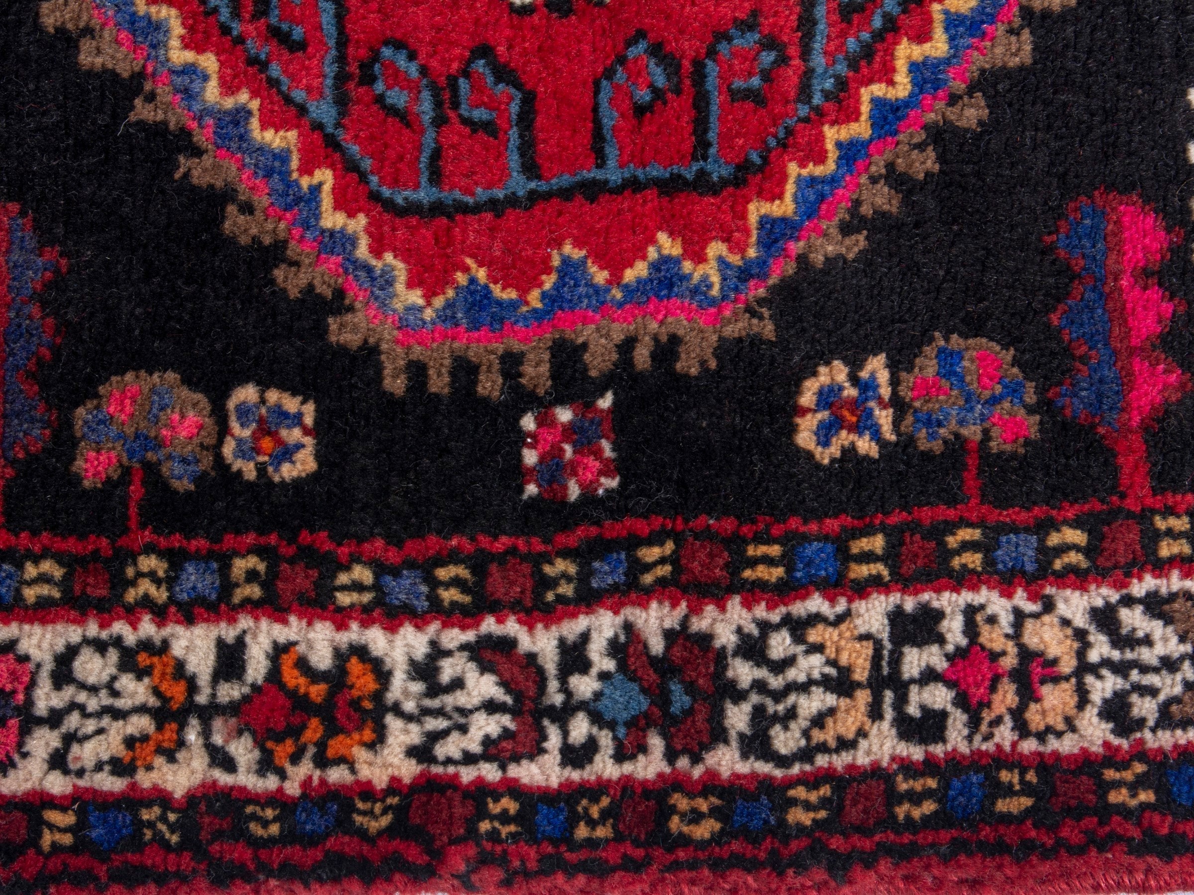 Persian Toyserkan accent rug in black and deep red, view 6 of 8