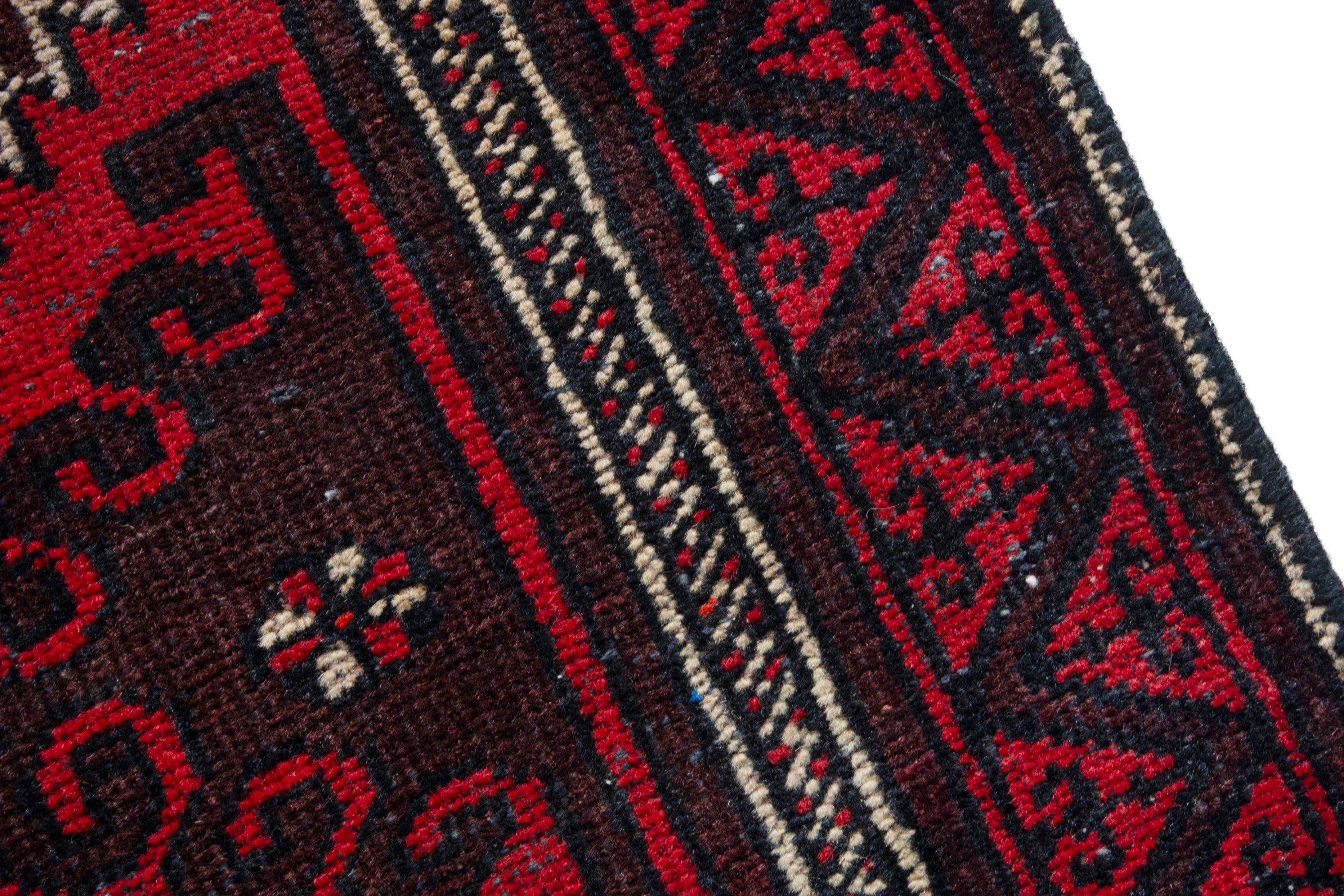 Persian Baluch accent rug in deep red and burgundy, view 7 of 17