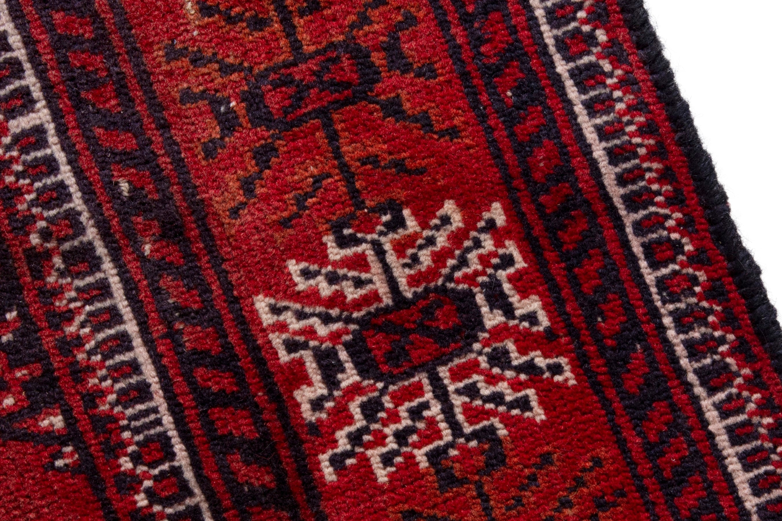 Persian Torkaman accent rug in deep red and faded red, view 7 of 18