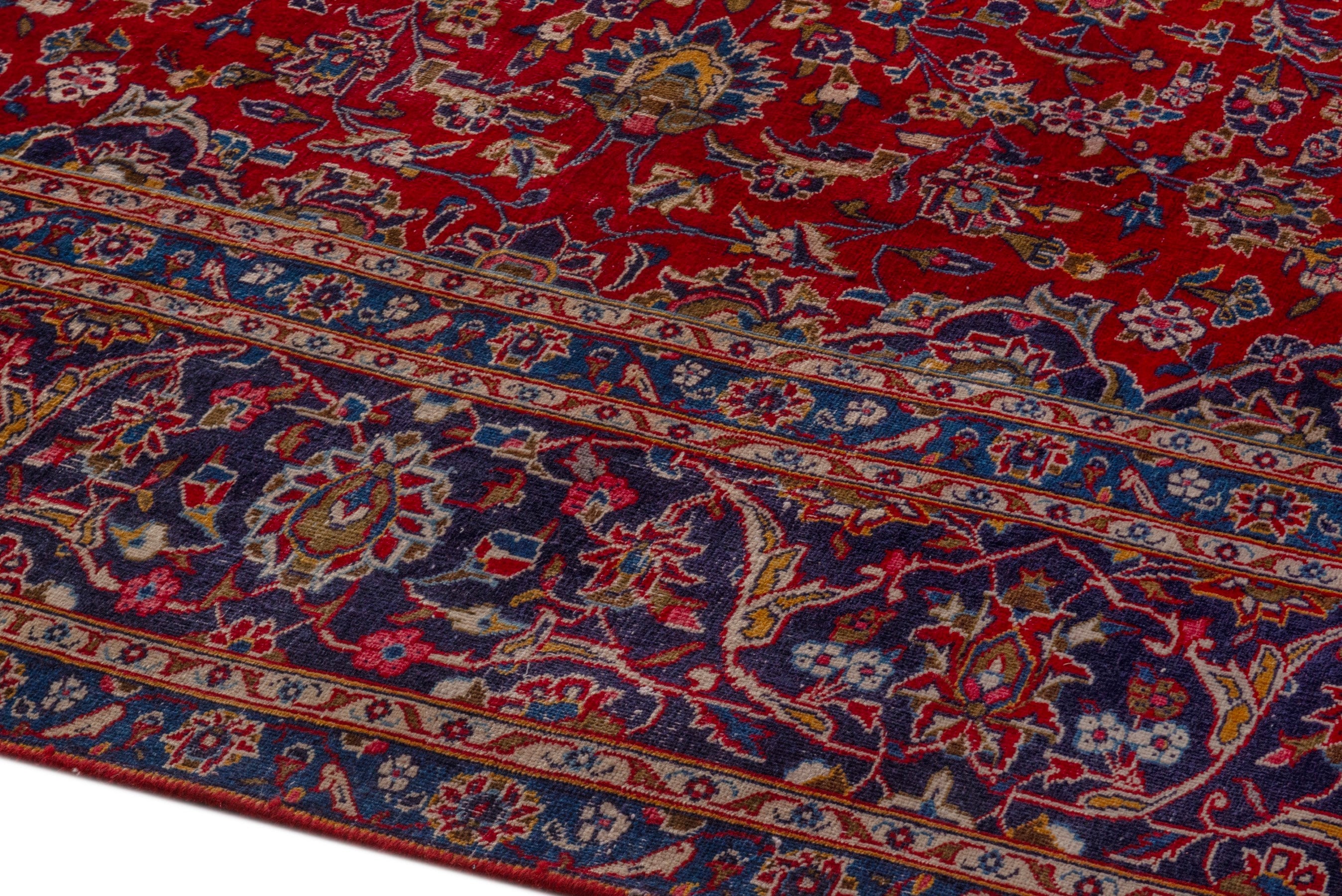 Persian Kashan oversized rug in deep red and dark blue, view 8 of 24