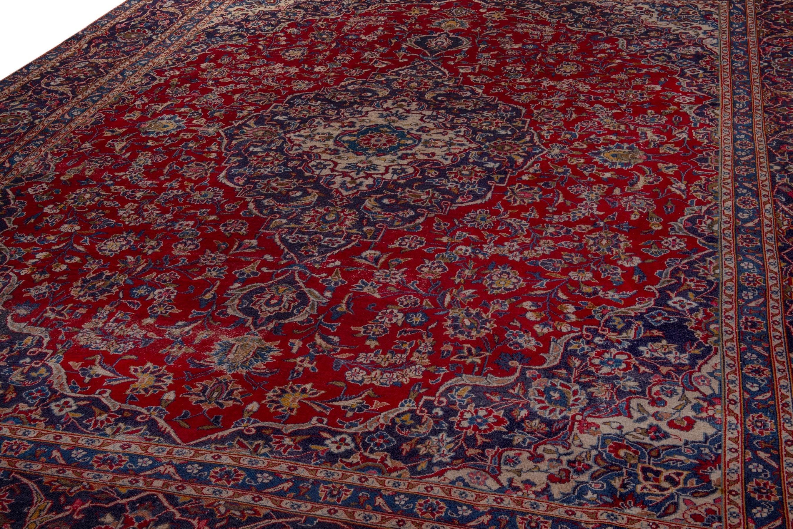 Persian Kashan oversized rug in deep red and dark blue, view 9 of 24