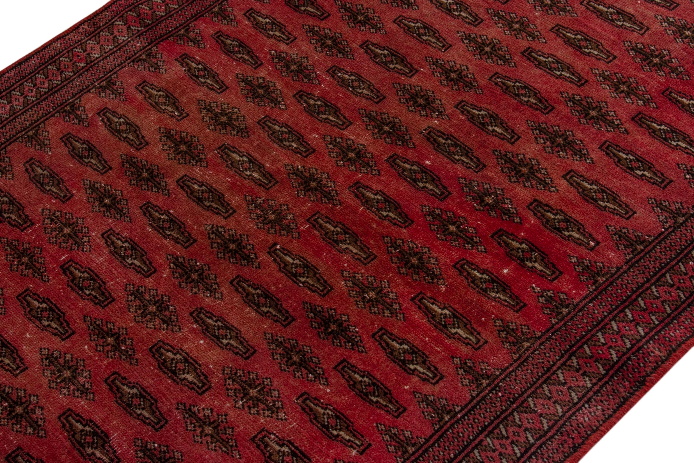 Persian Torkaman accent rug in deep red and dark brown, view 4 of 17