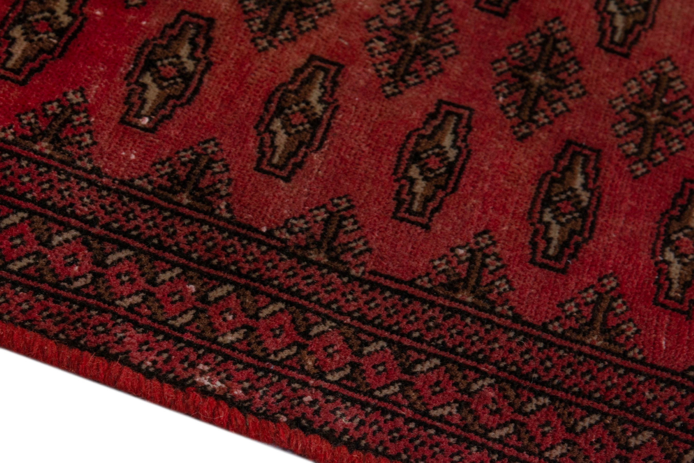 Persian Torkaman accent rug in deep red and dark brown, view 8 of 17