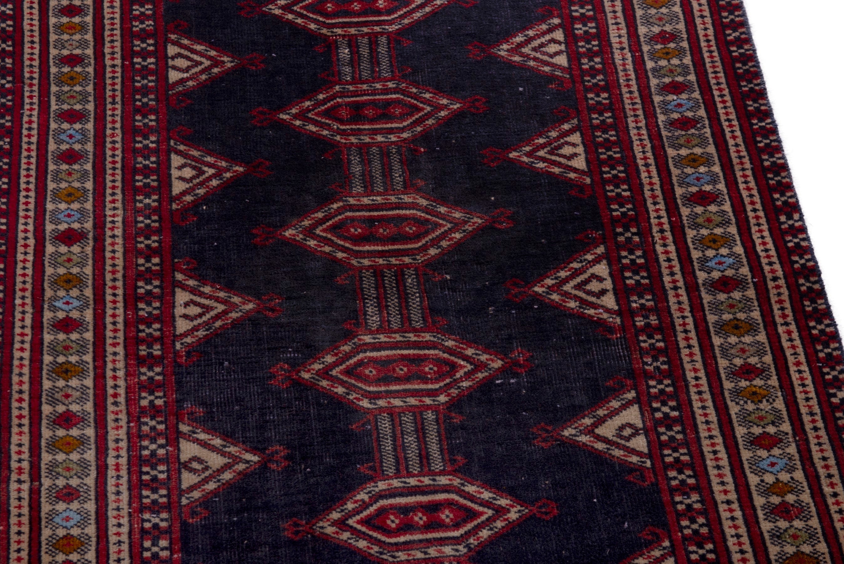 Persian Torkaman accent rug in navy and deep red, view 10 of 17