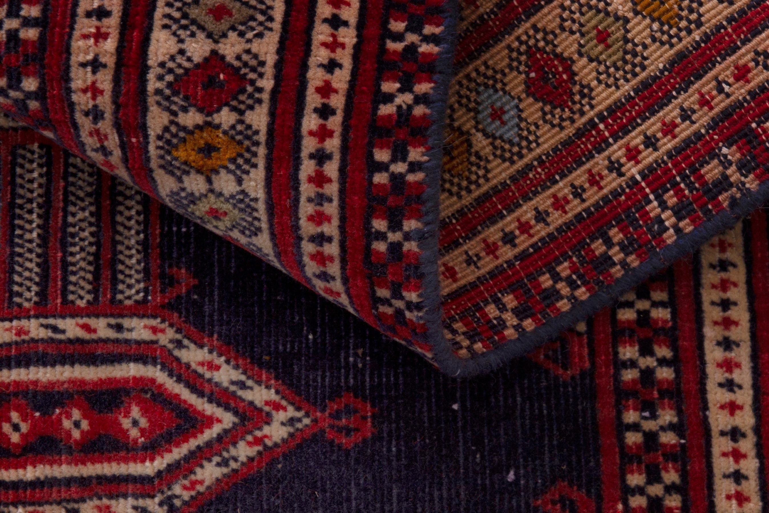 Persian Torkaman accent rug in navy and deep red, view 16 of 17