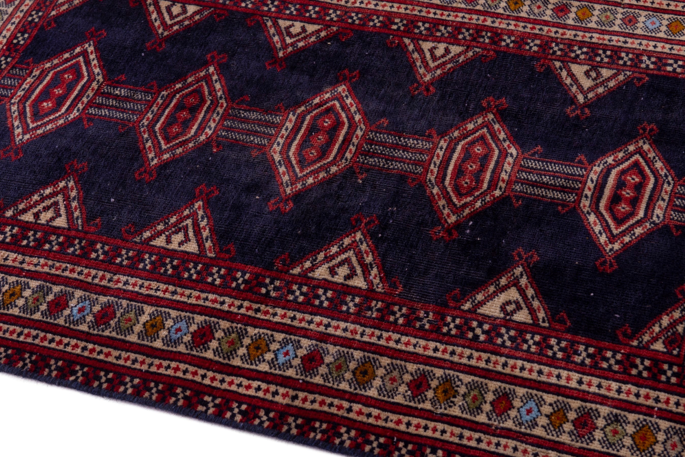 Persian Torkaman accent rug in navy and deep red, view 8 of 17