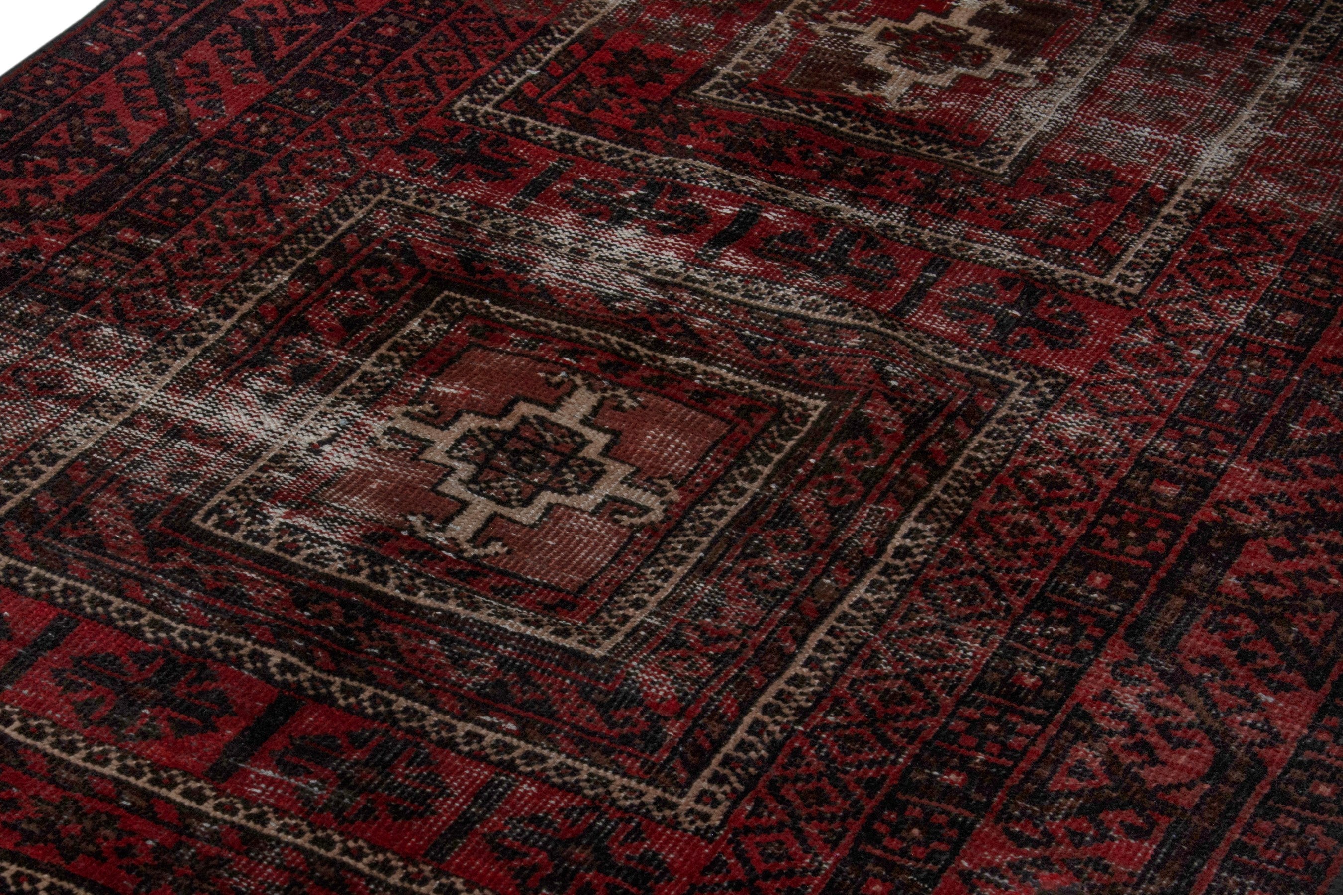 Persian Baluch runner rug in deep red and faded red, view 9 of 18