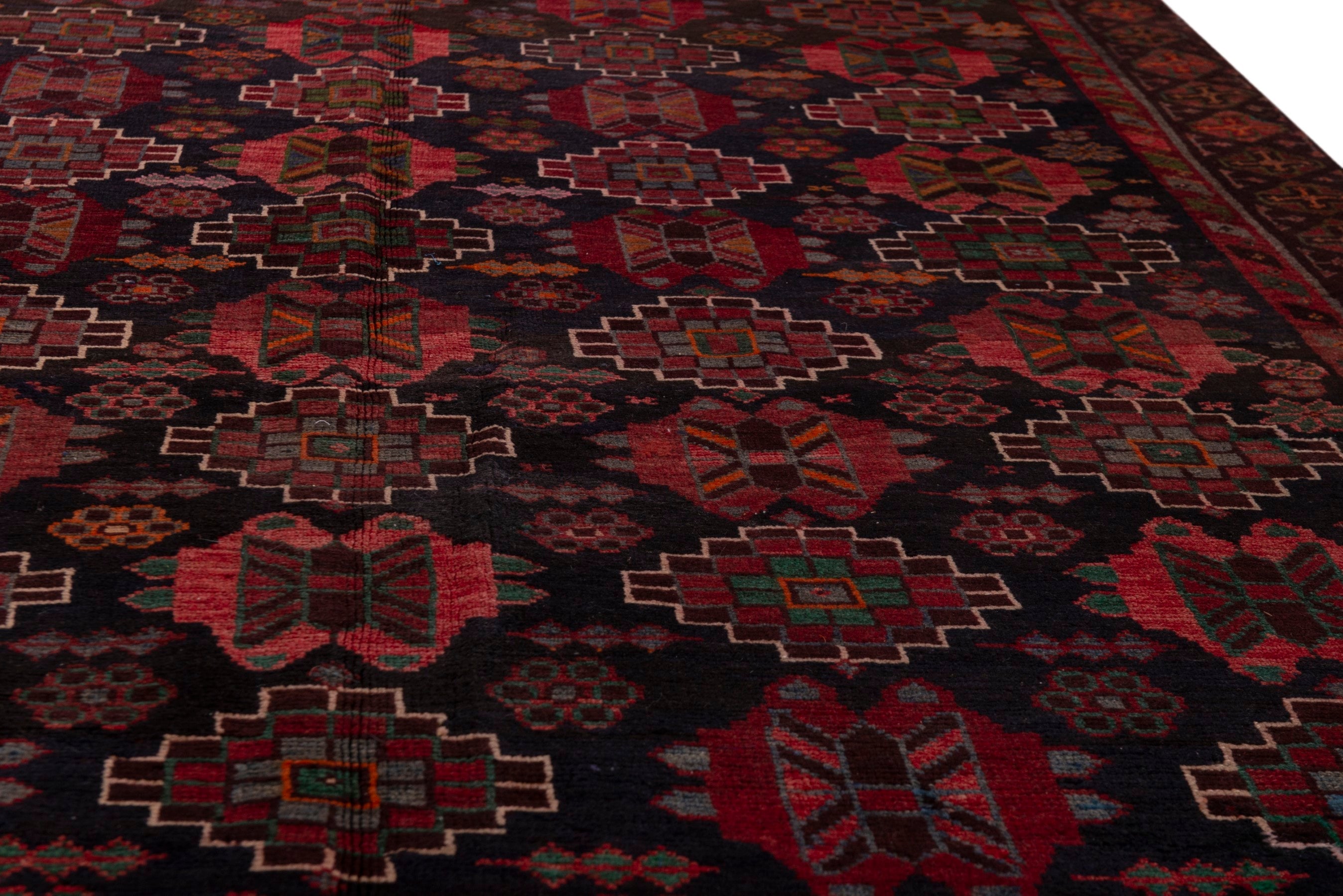 Persian Ferdos area rug in navy and deep red, view 10 of 20