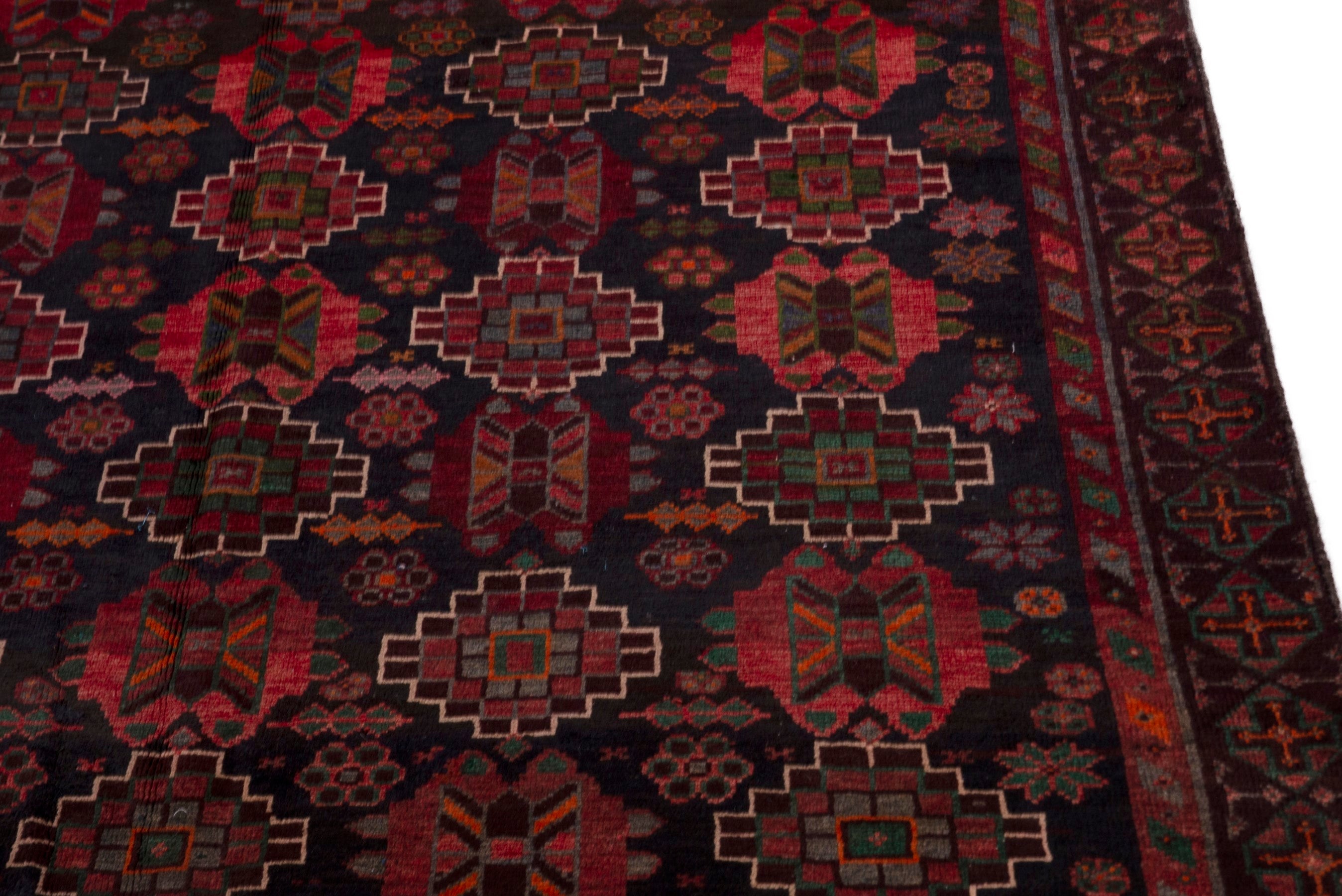 Persian Ferdos area rug in navy and deep red, view 7 of 20
