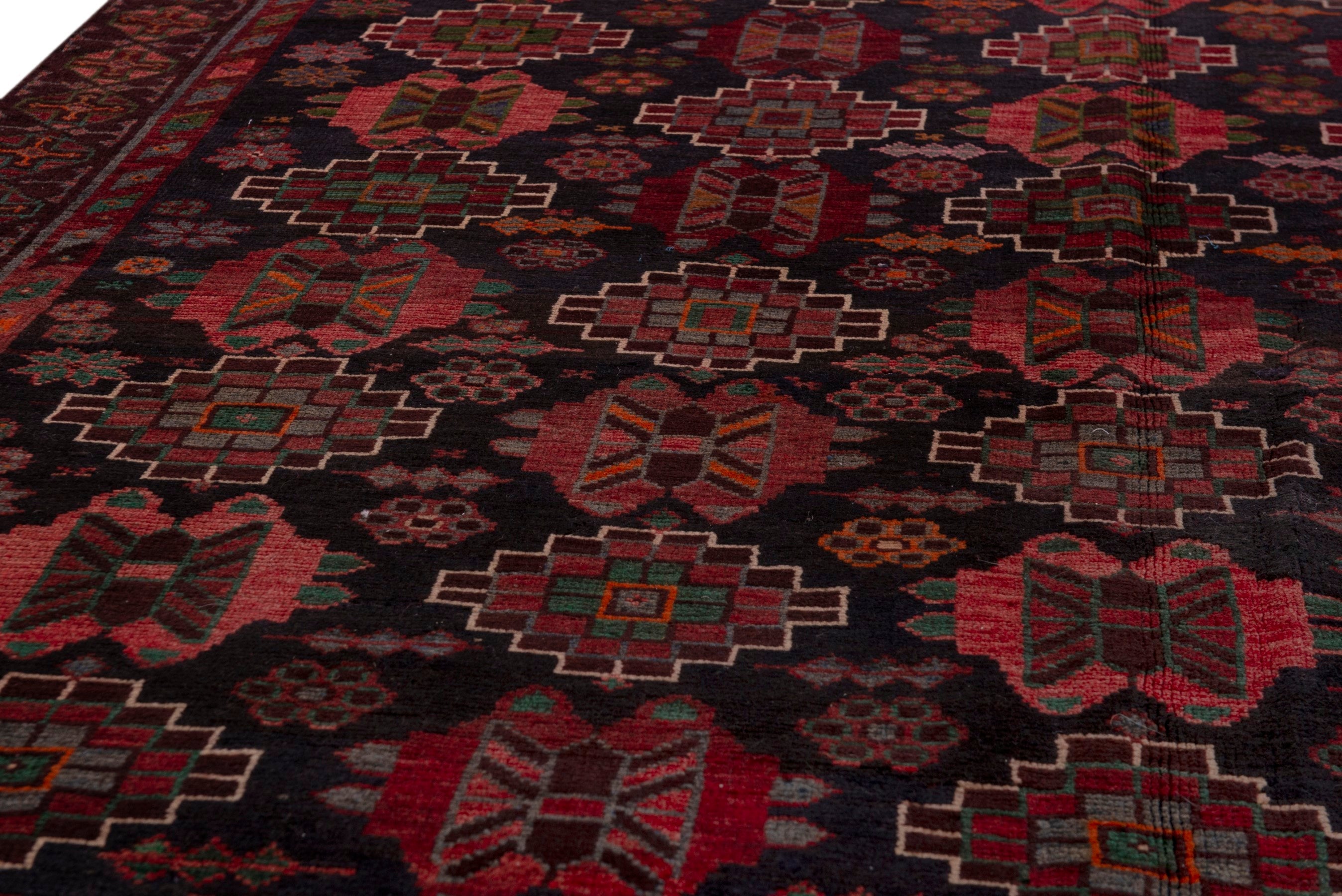 Persian Ferdos area rug in navy and deep red, view 9 of 20