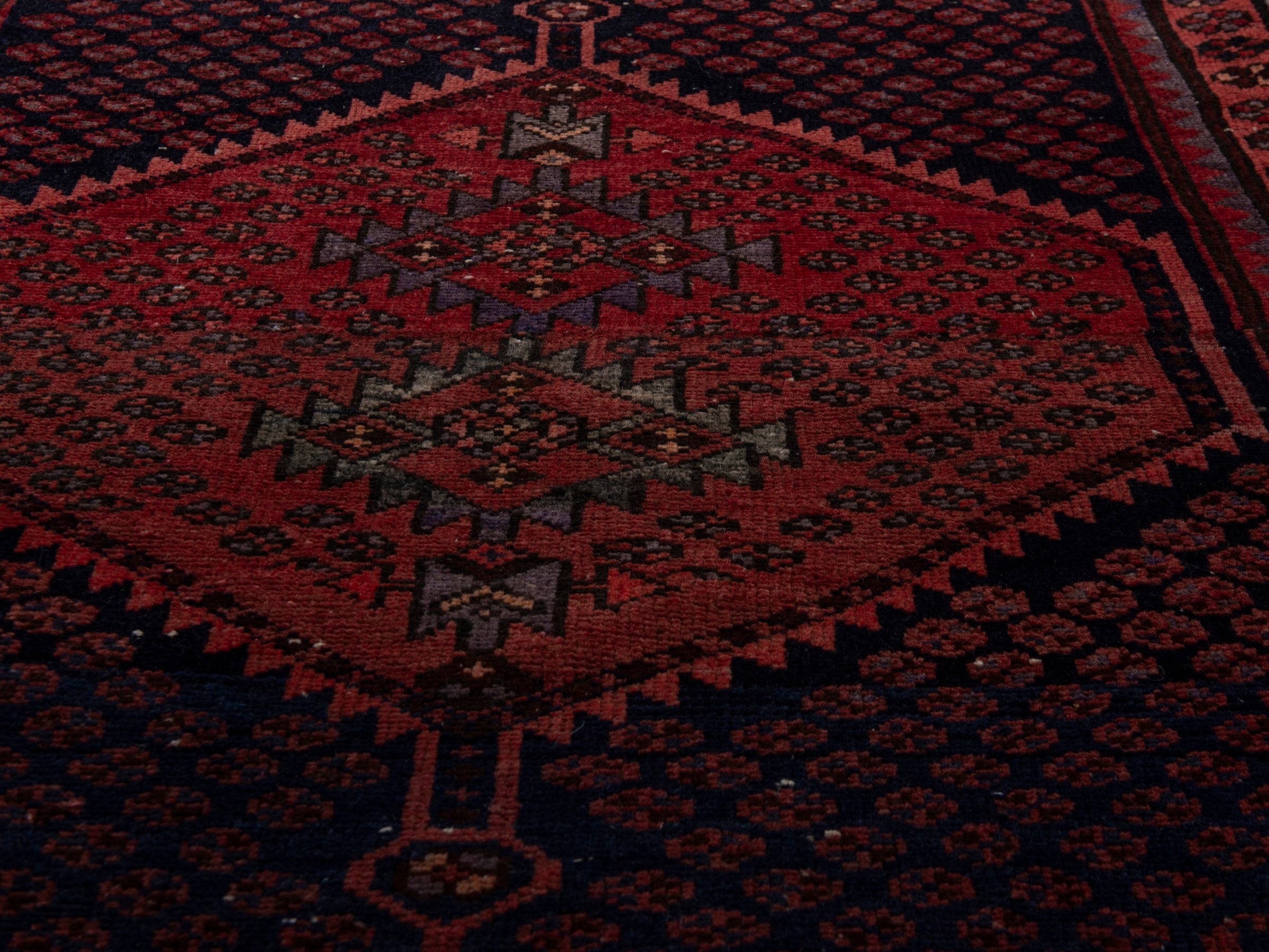 Persian Zanjan accent rug in navy and rust, view 10 of 17
