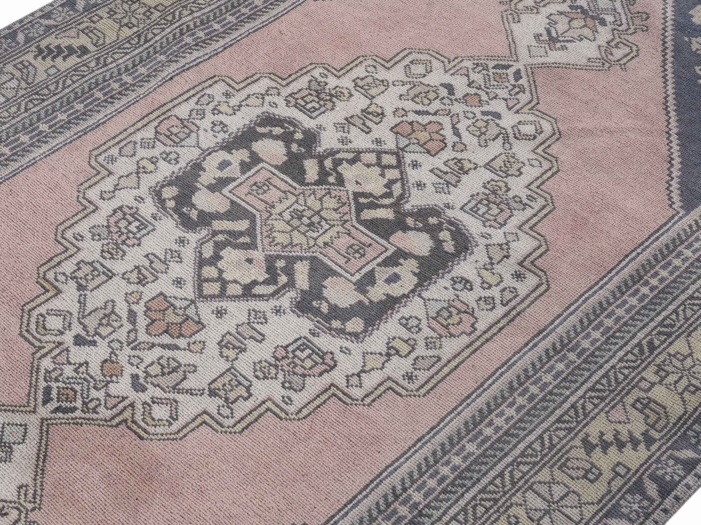 Turkish Anatolian area rug in navy and muted pink, view 5 of 10