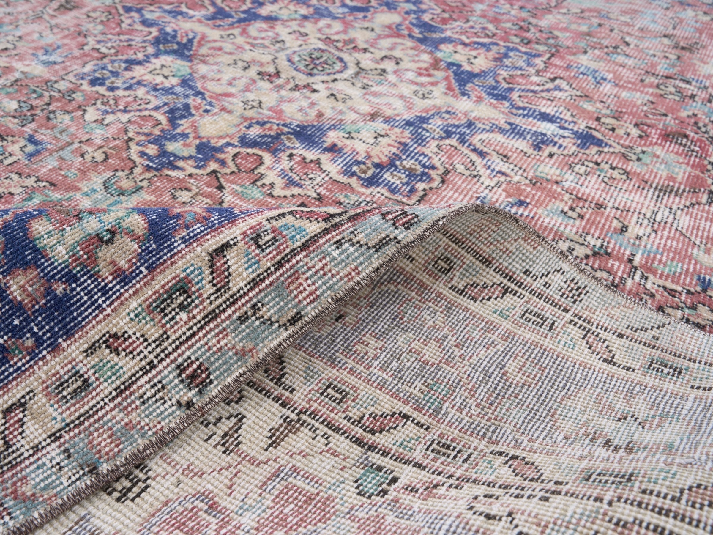 Turkish Isparta area rug in faded red and deep indigo, view 9 of 10
