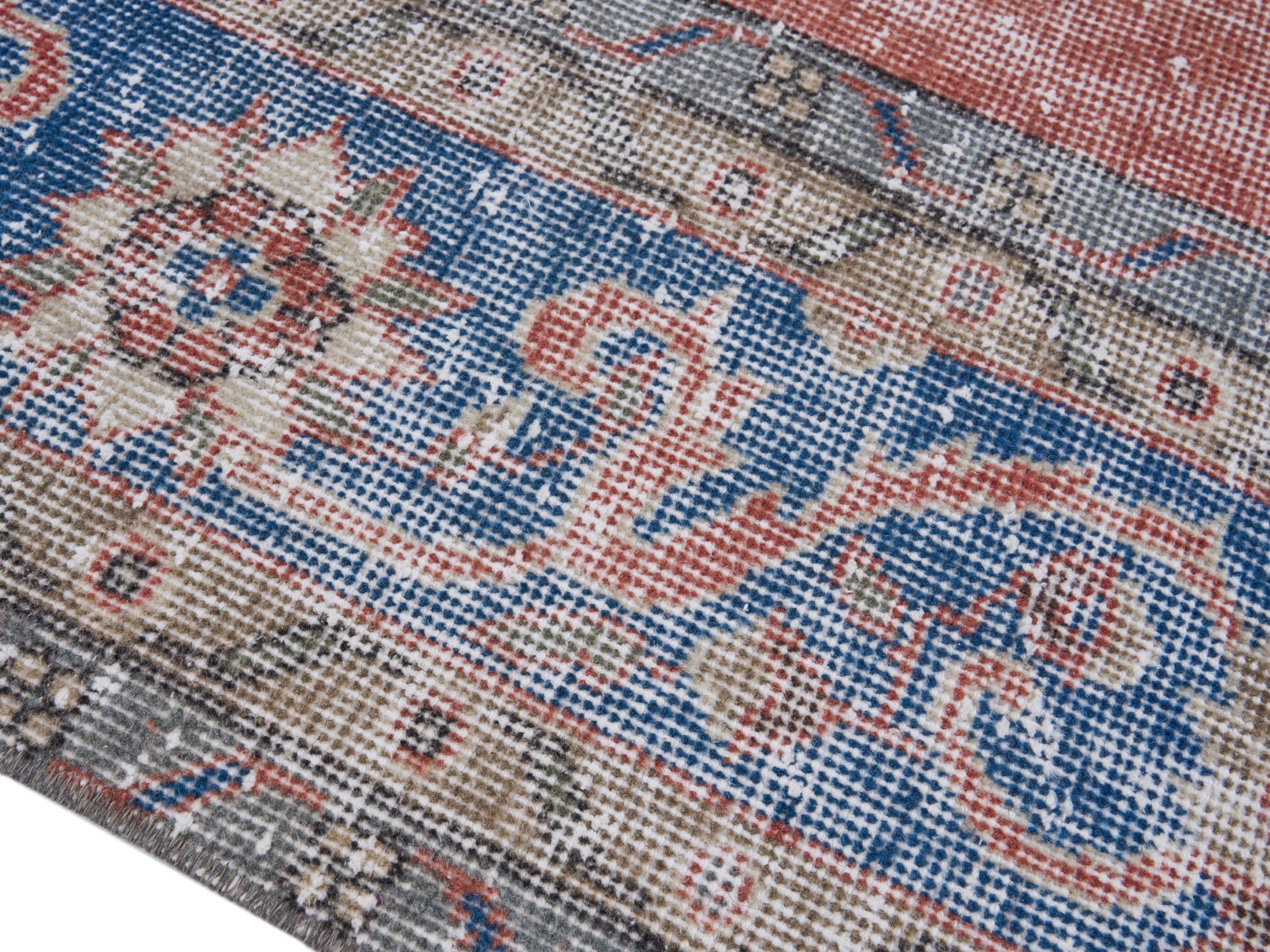 Turkish Isparta oversized rug in terracotta and dark blue, view 6 of 10
