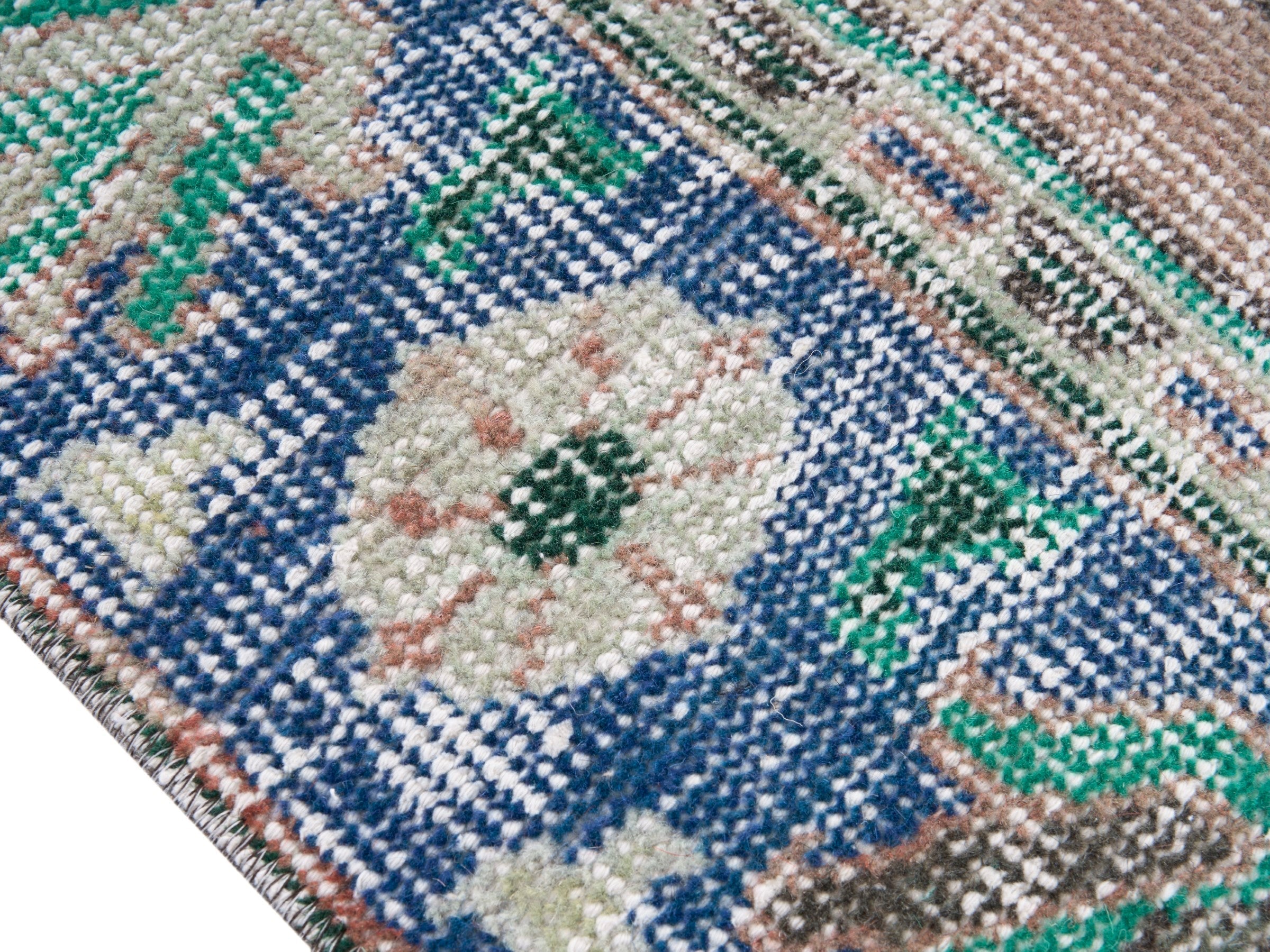Turkish Manisa area rug in muted pink and navy, view 6 of 10