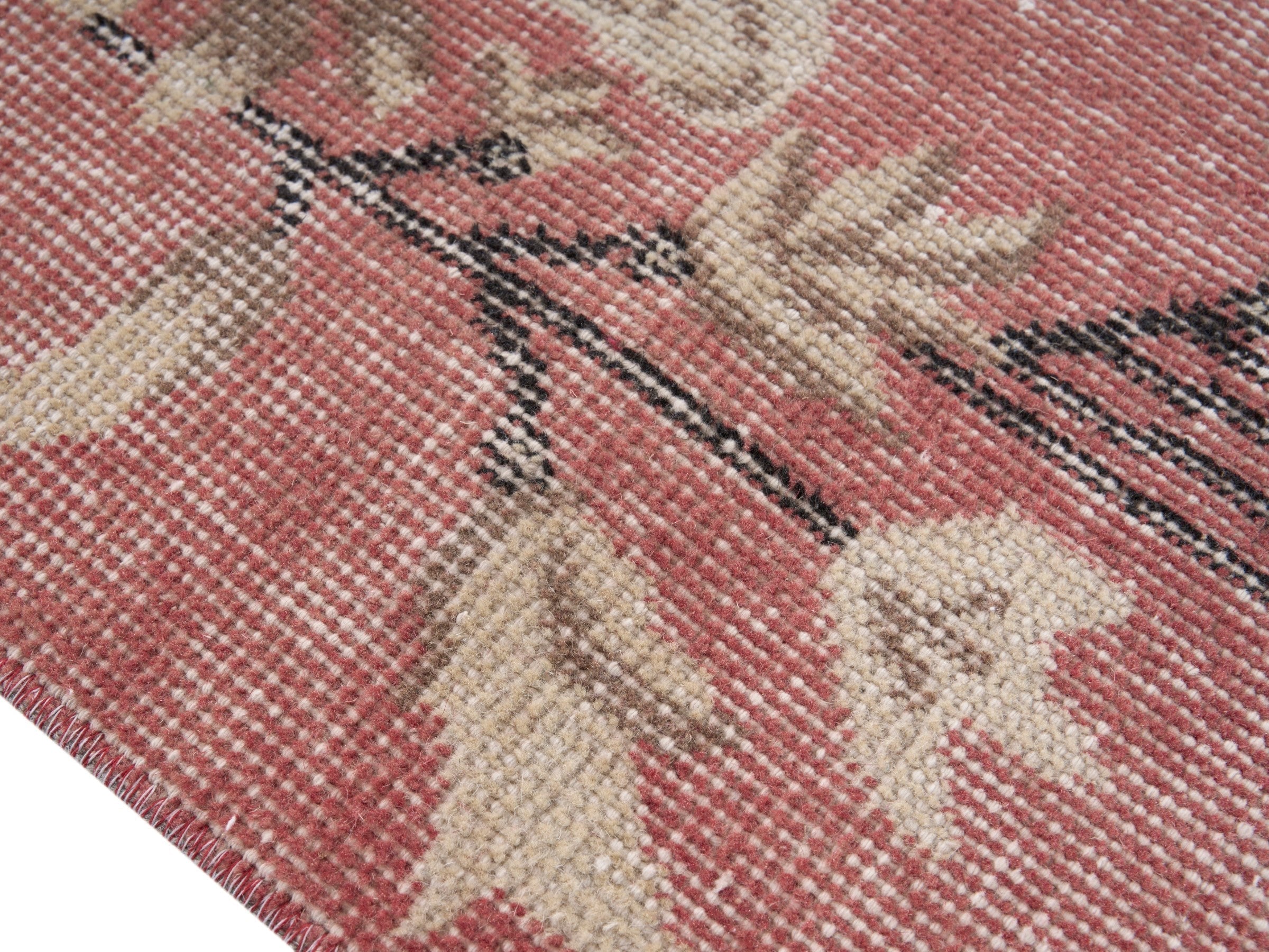 Turkish Isparta area rug in faded red and muted pink, view 6 of 10