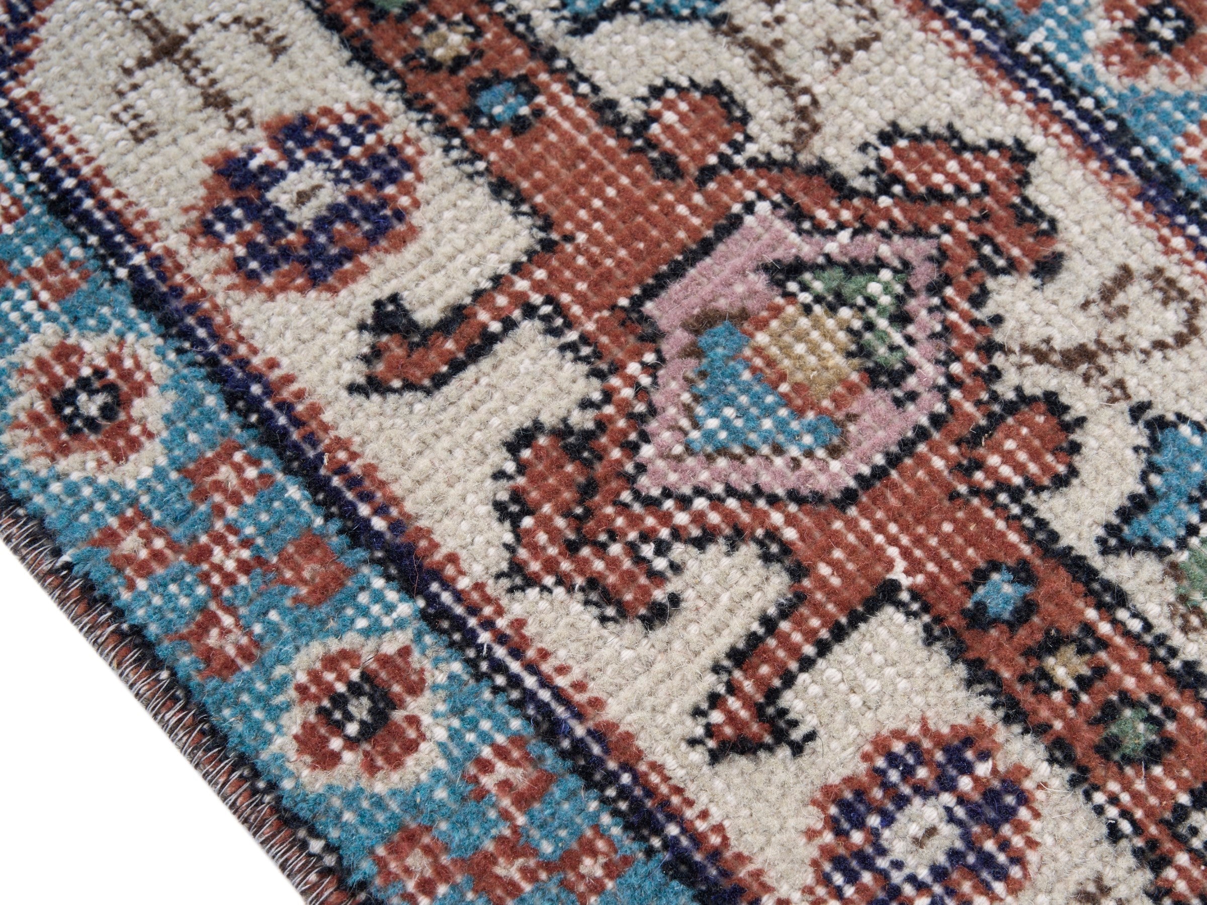 Turkish Isparta area rug in rust and navy, view 6 of 10
