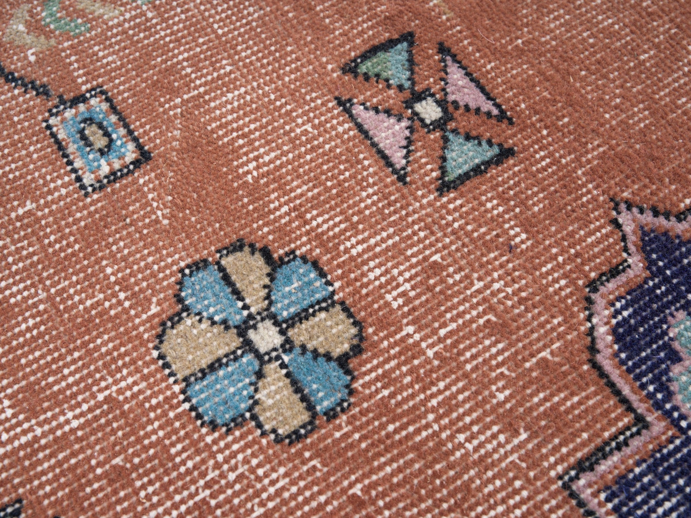 Turkish Isparta area rug in rust and navy, view 7 of 10