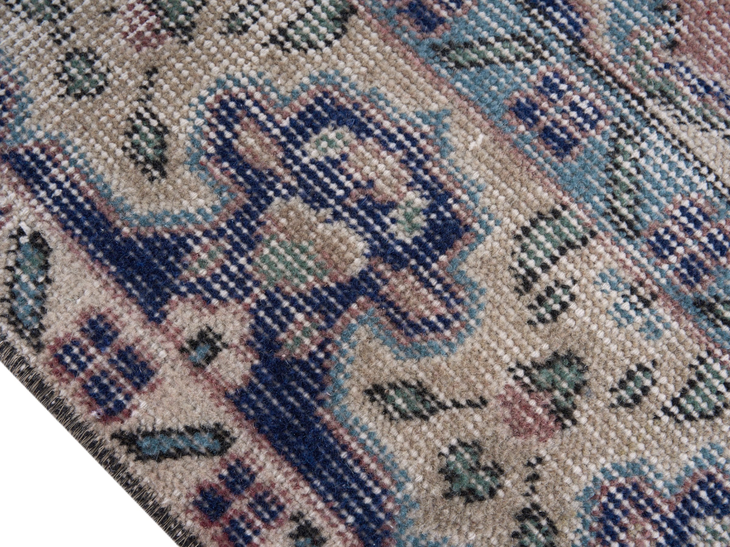 Turkish Isparta area rug in dusty rose and navy, view 6 of 10