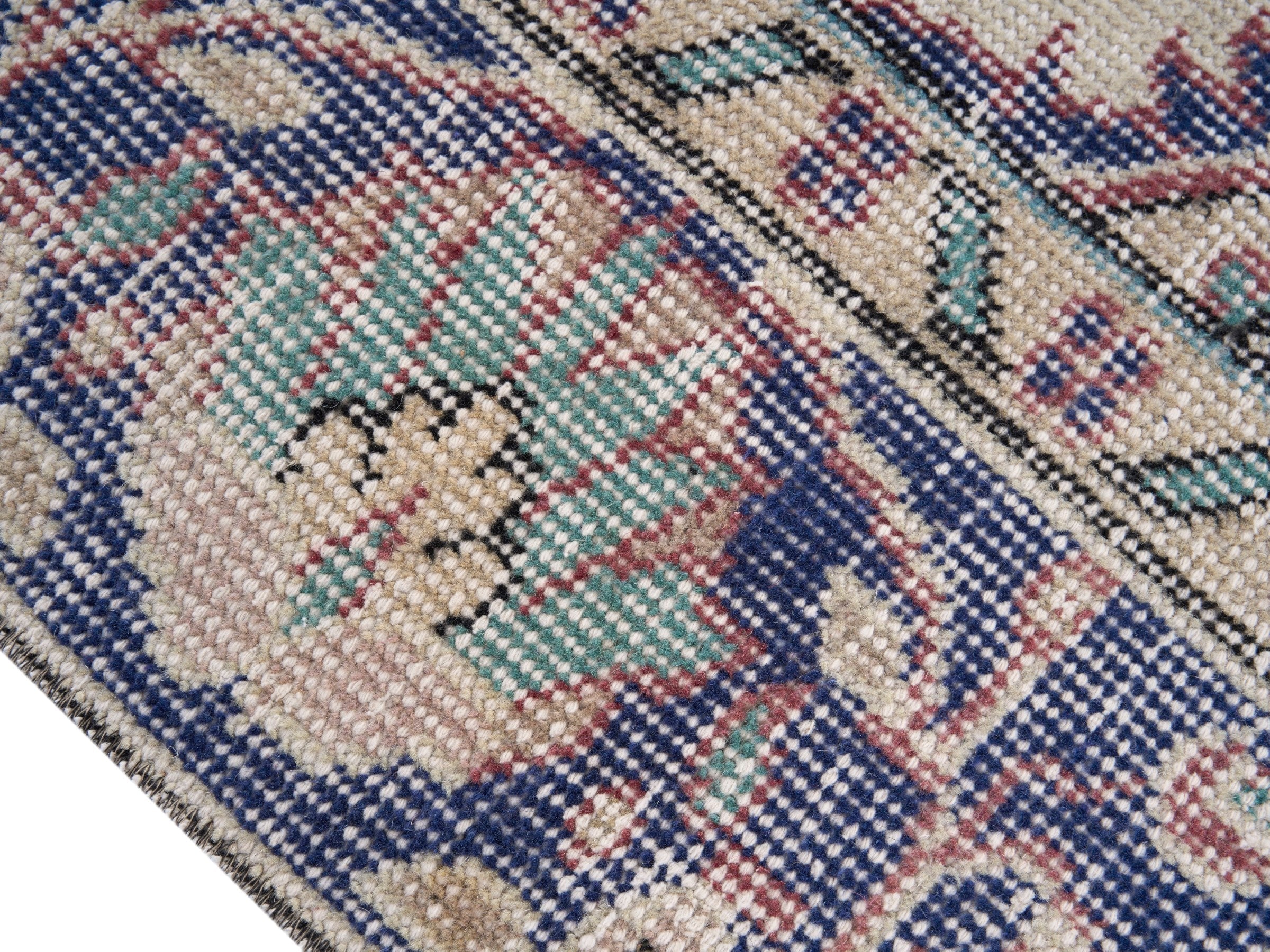 Turkish Isparta area rug in dusty rose and navy, view 6 of 10