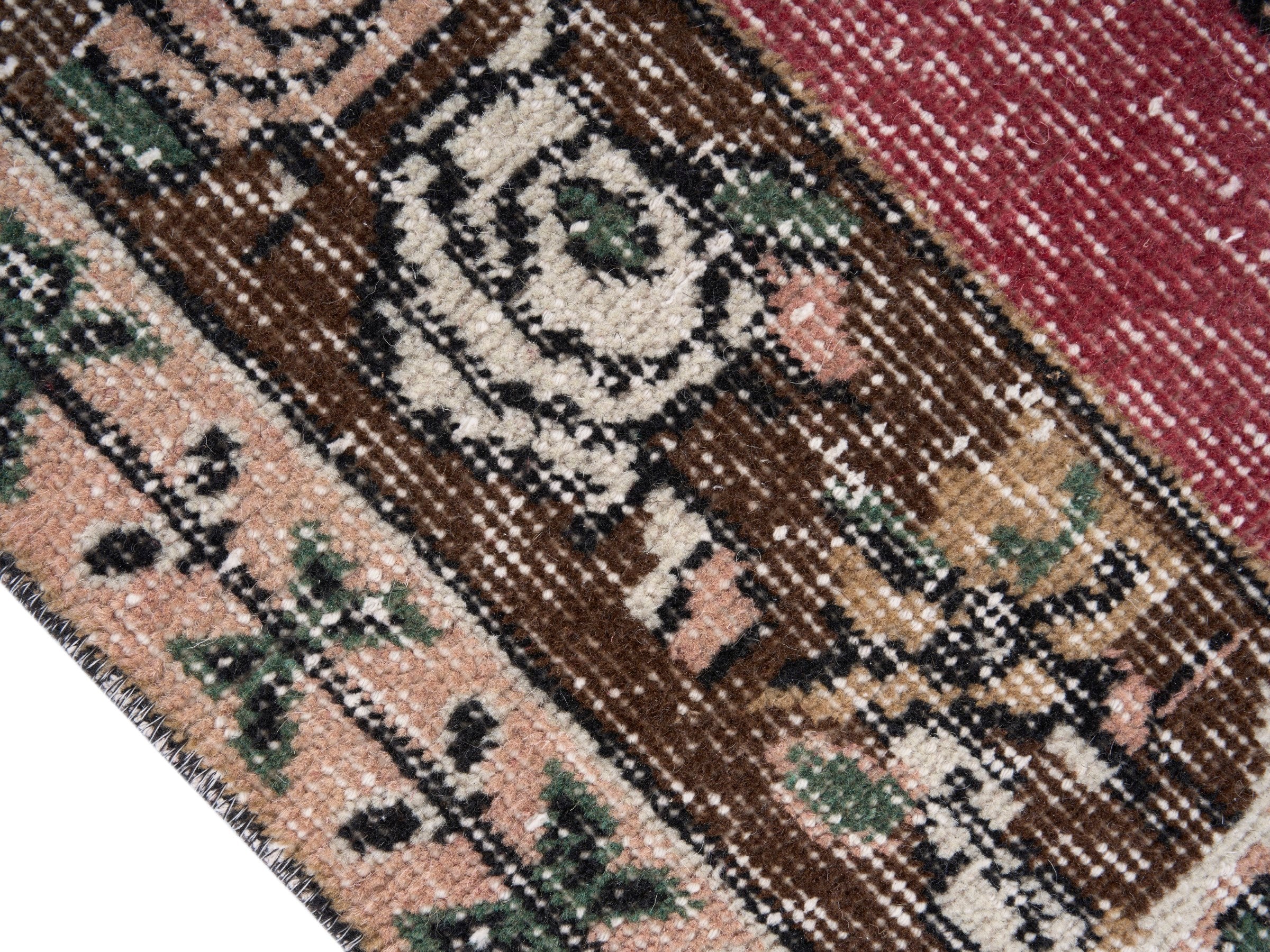 Turkish Isparta area rug in muted pink and dark brown, view 6 of 10